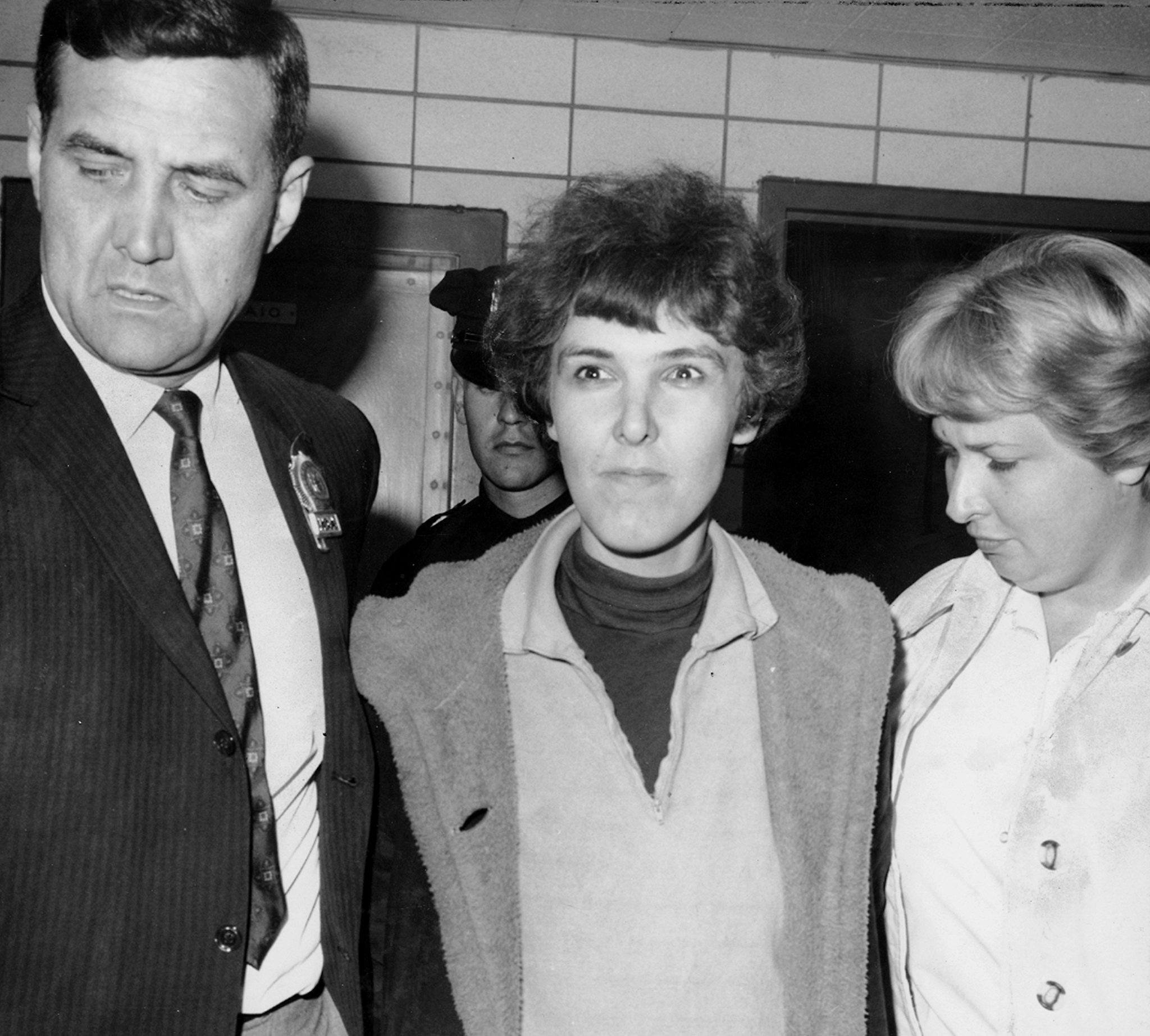 Detective Frederick Stepat and policewoman McCarthy escort Valeria Solanas, 28, into 13th precinct, for the shooting of Andy Warhol, on June 3, 1968, in New York City