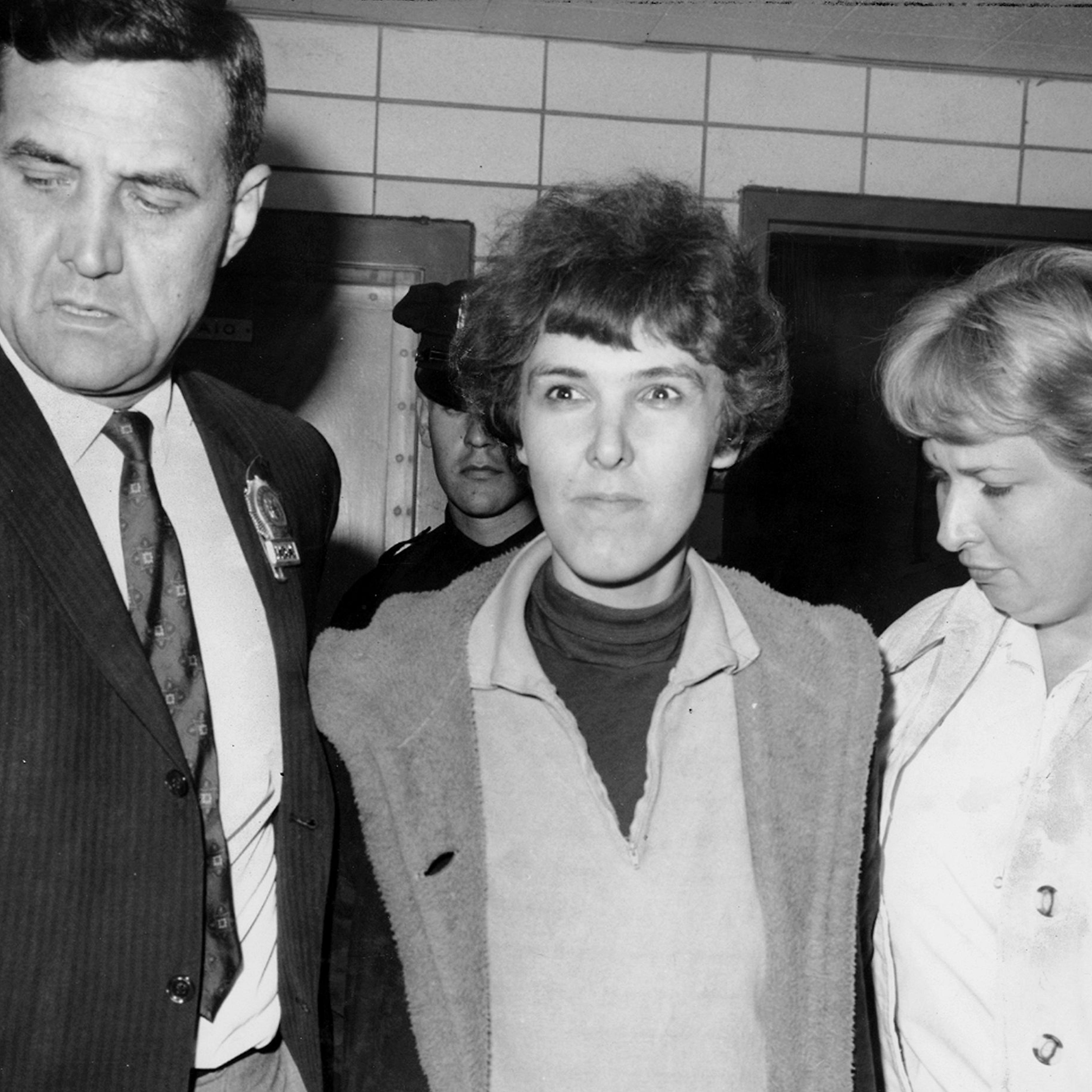 Detective Frederick Stepat and policewoman McCarthy escort Valeria Solanas, 28, into 13th precinct, for the shooting of Andy Warhol, on June 3, 1968, in New York City