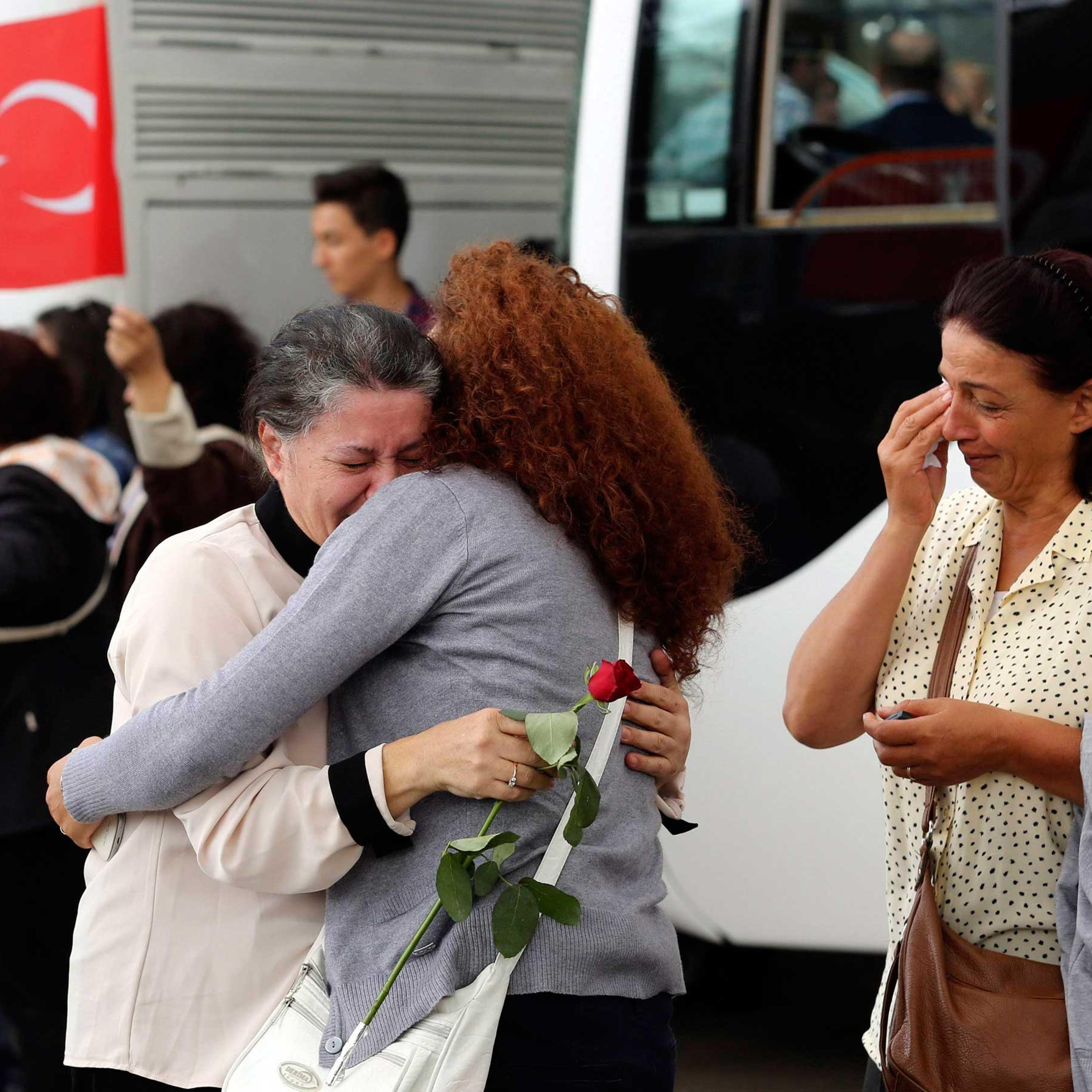 Employee at Turkey's consulate in Mosul is welcomed by her relatives at Esenboga airport in Ankara