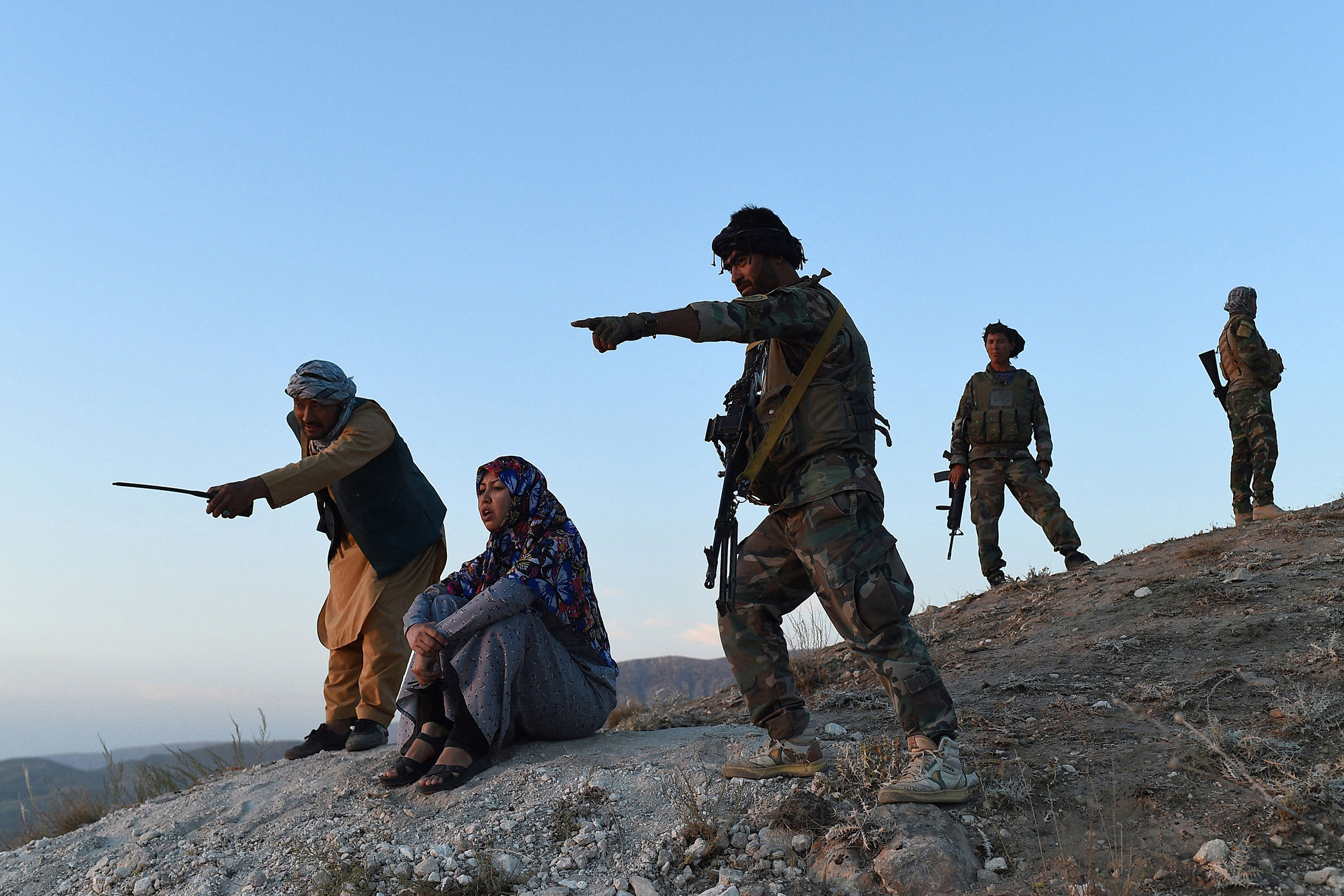 District governor Salima Mazari (second from left) looks on from a hill while accompanied by security personnel near the frontlines against the Taliban, at Charkint district in Balkh province, Afghanistan, on July 14. 