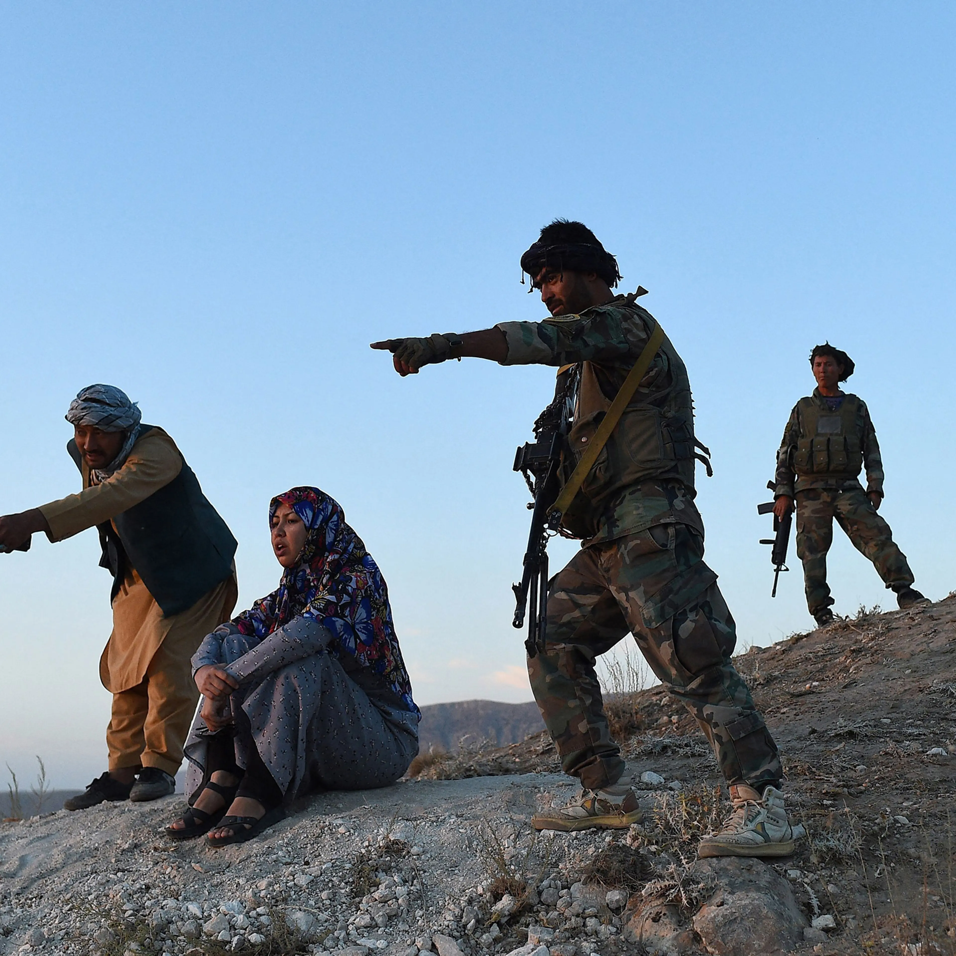 District governor Salima Mazari (second from left) looks on from a hill while accompanied by security personnel near the frontlines against the Taliban, at Charkint district in Balkh province, Afghanistan, on July 14.