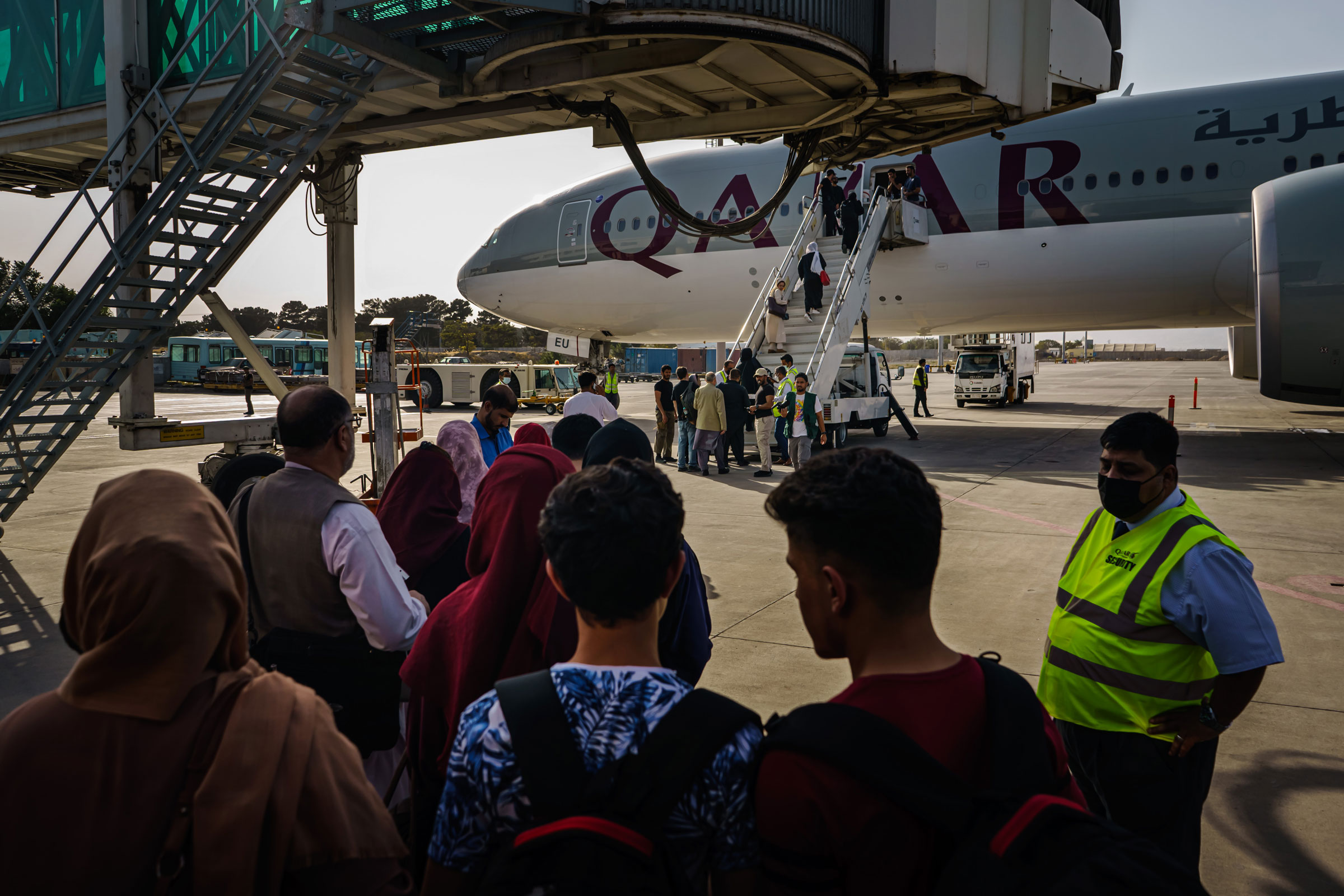 People prepare to board an evacuation flight out of Kabul in October 2021