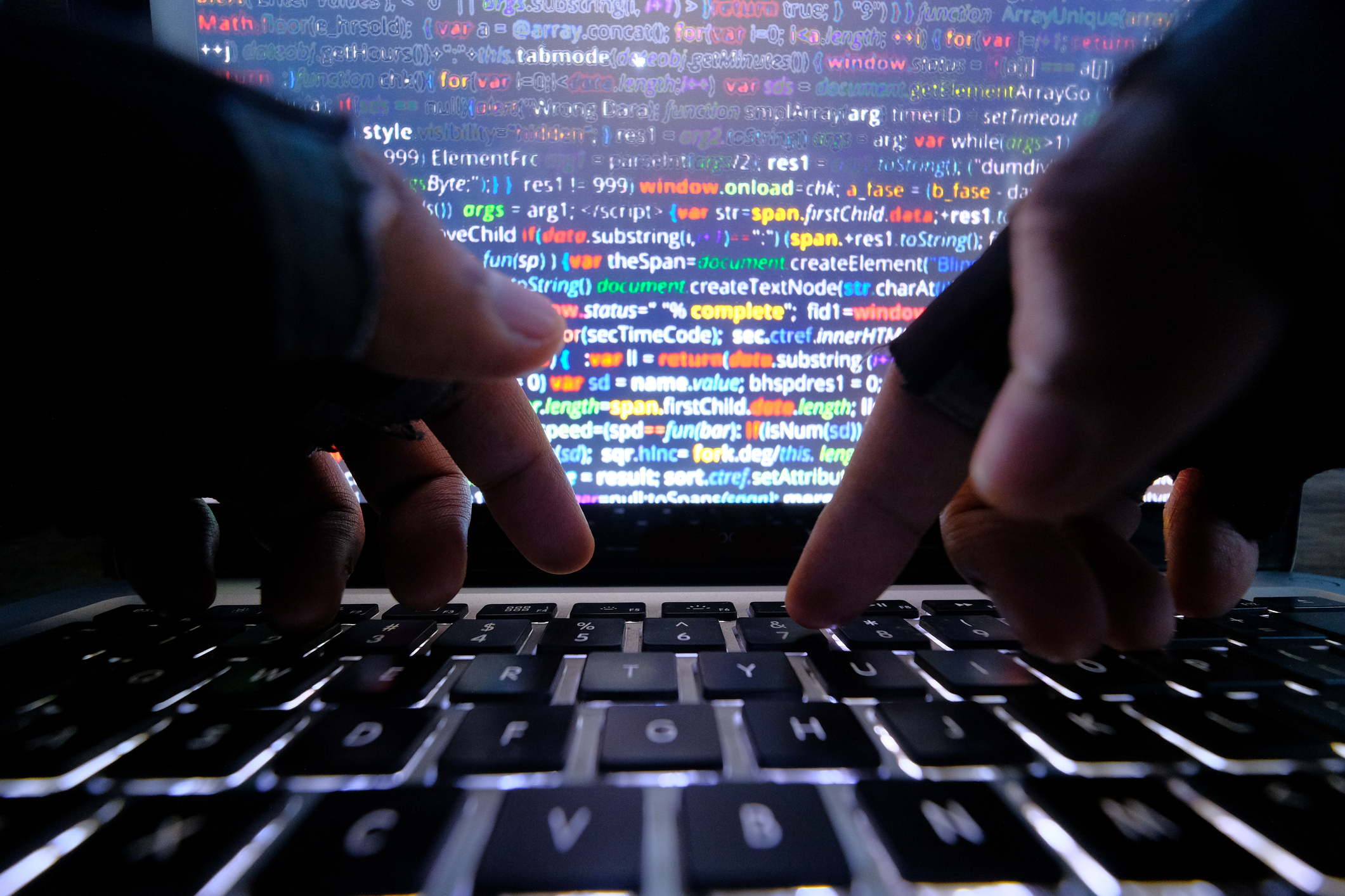 close up of hacker hand typing code on laptop for hacking a system