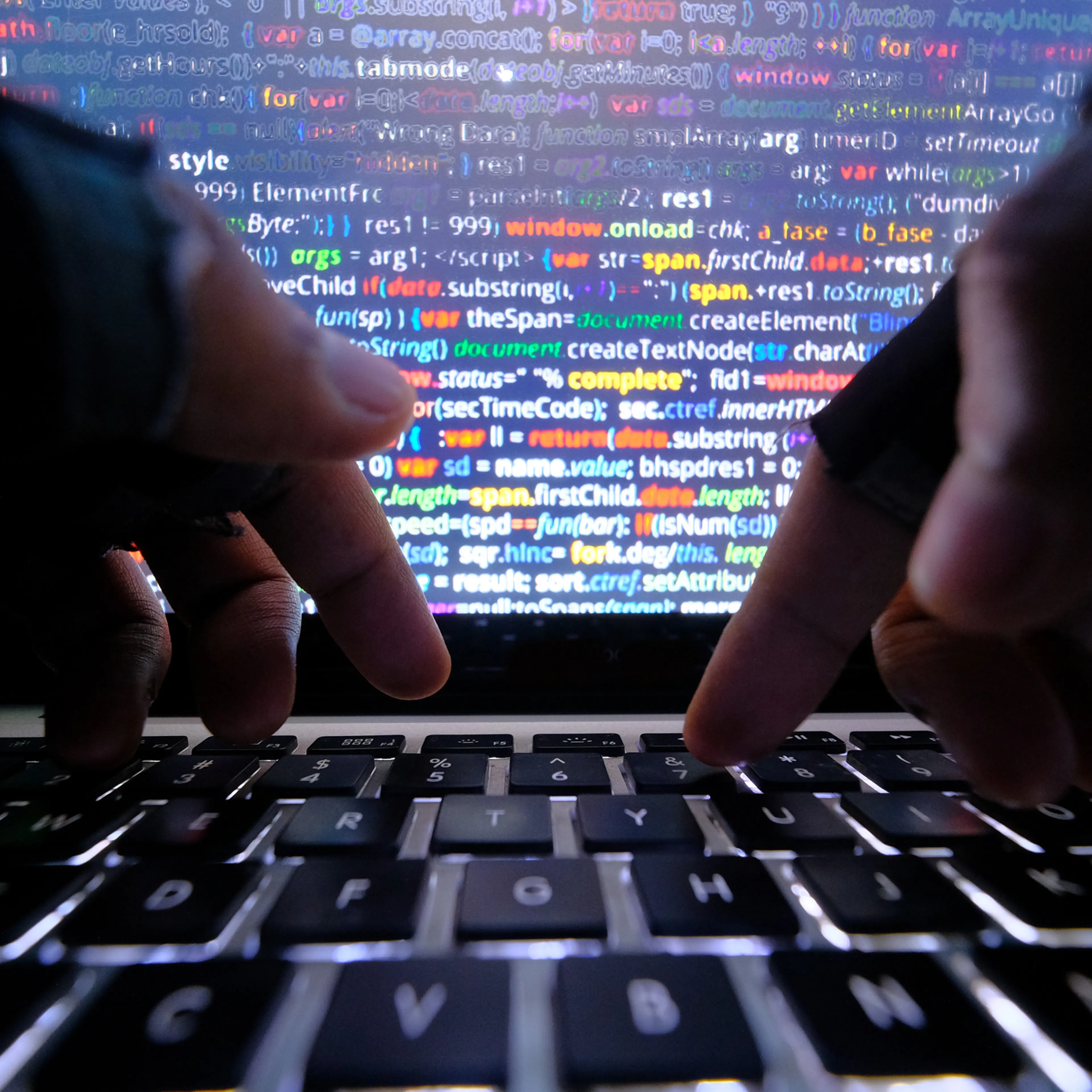 close up of hacker hand typing code on laptop for hacking a system