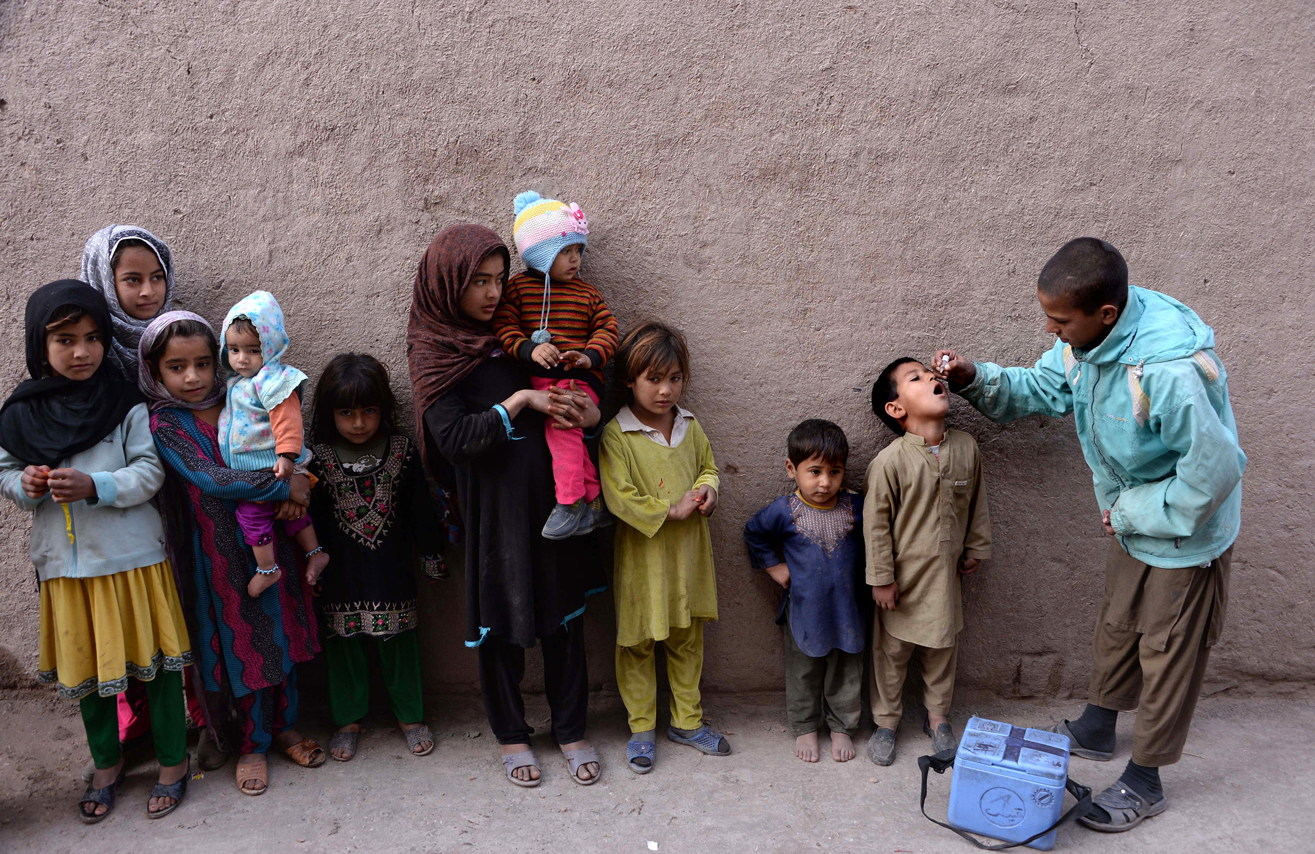 An Afghan health worker administers the polio vaccine to a child during a vaccination campaign on the outskirts of Jalalabad on Dec. 2, 2015.