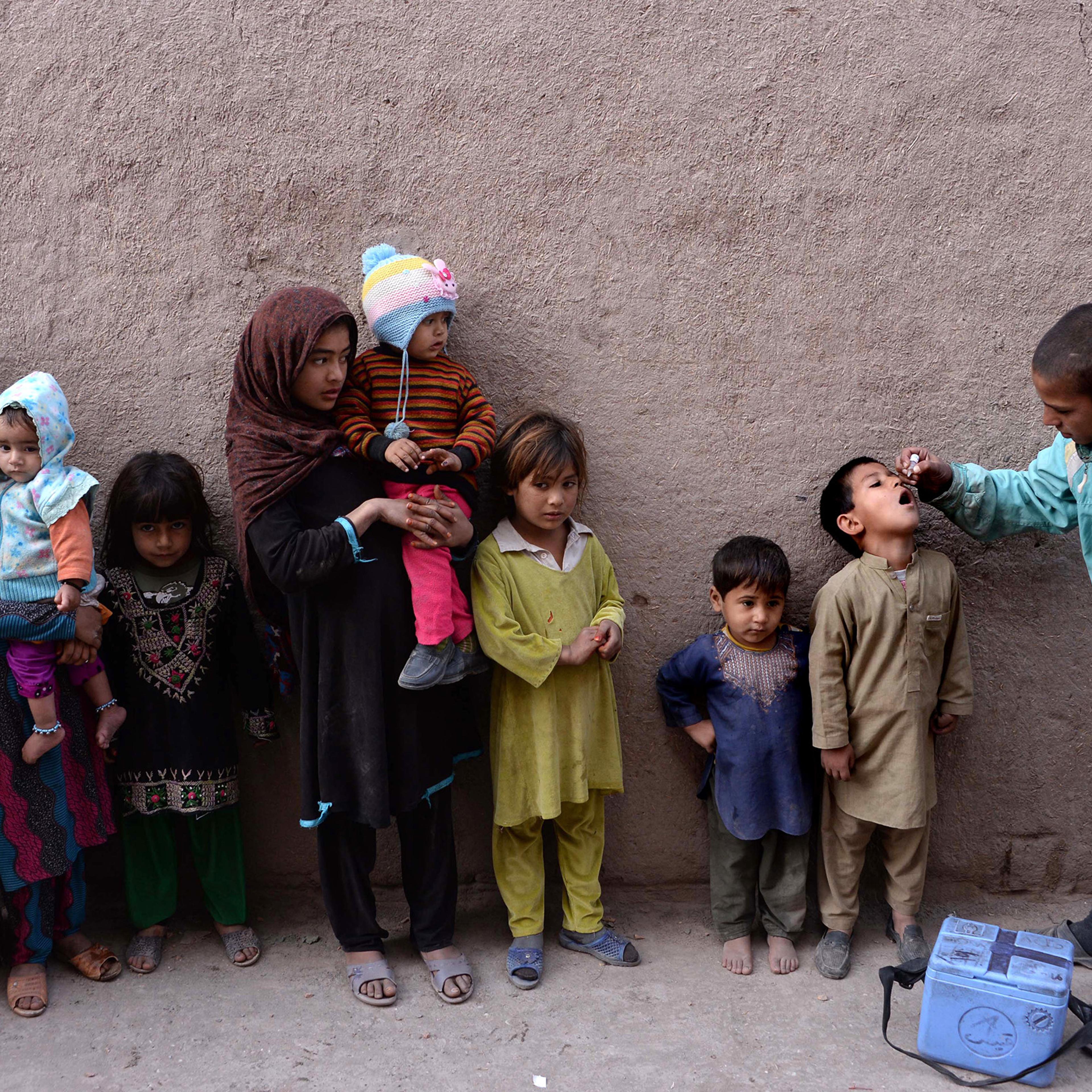 An Afghan health worker administers the polio vaccine to a child during a vaccination campaign on the outskirts of Jalalabad on Dec. 2, 2015.