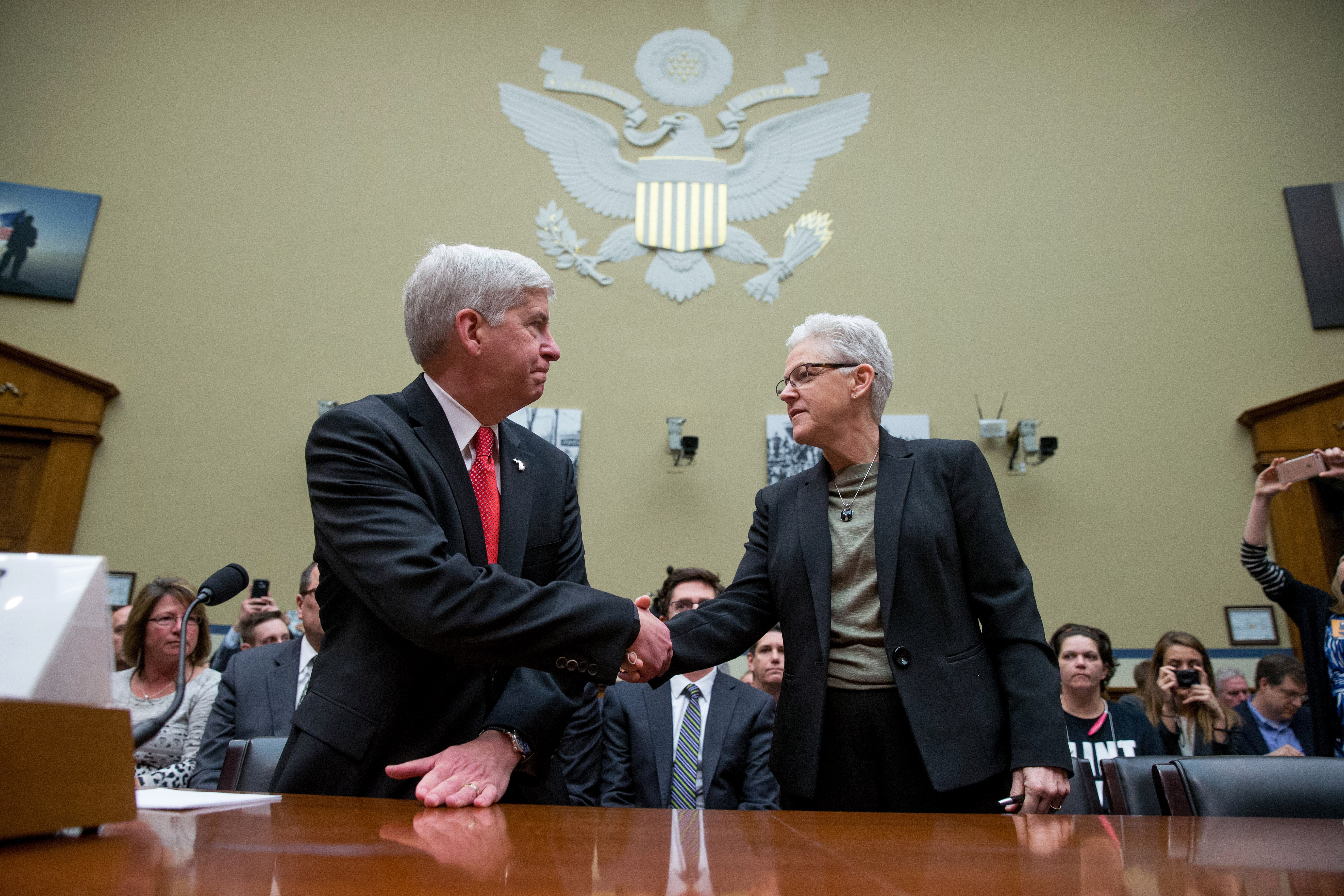 Michigan Gov. Rick Snyder and EPA Administrator Gina McCarthy greet each other as they arrive to testify before a House Oversight and Government Reform Committee hearing in Washington on March 17, 2016, to look into the circumstances surrounding high lev