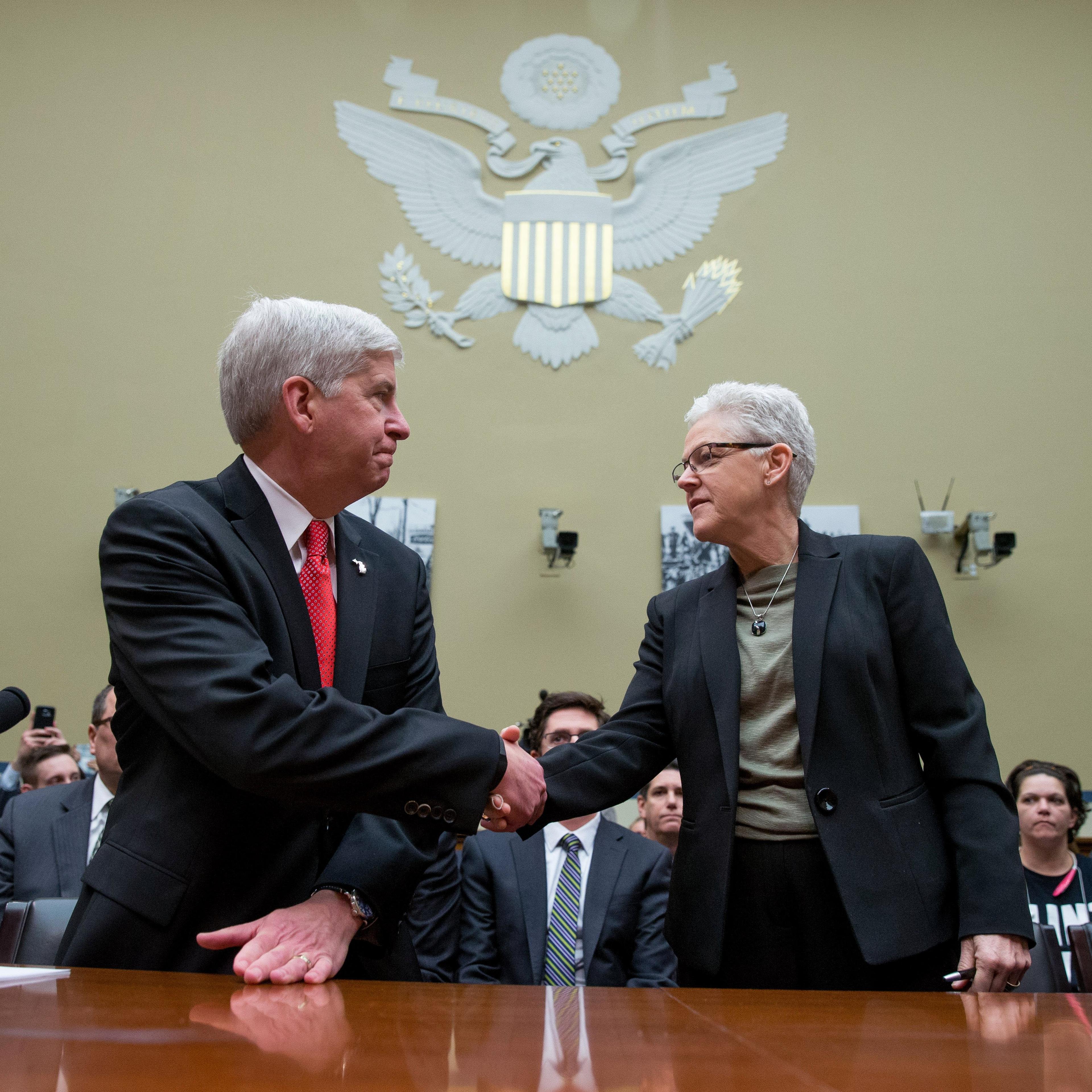 Michigan Gov. Rick Snyder and EPA Administrator Gina McCarthy greet each other as they arrive to testify before a House Oversight and Government Reform Committee hearing in Washington on March 17, 2016, to look into the circumstances surrounding high lev