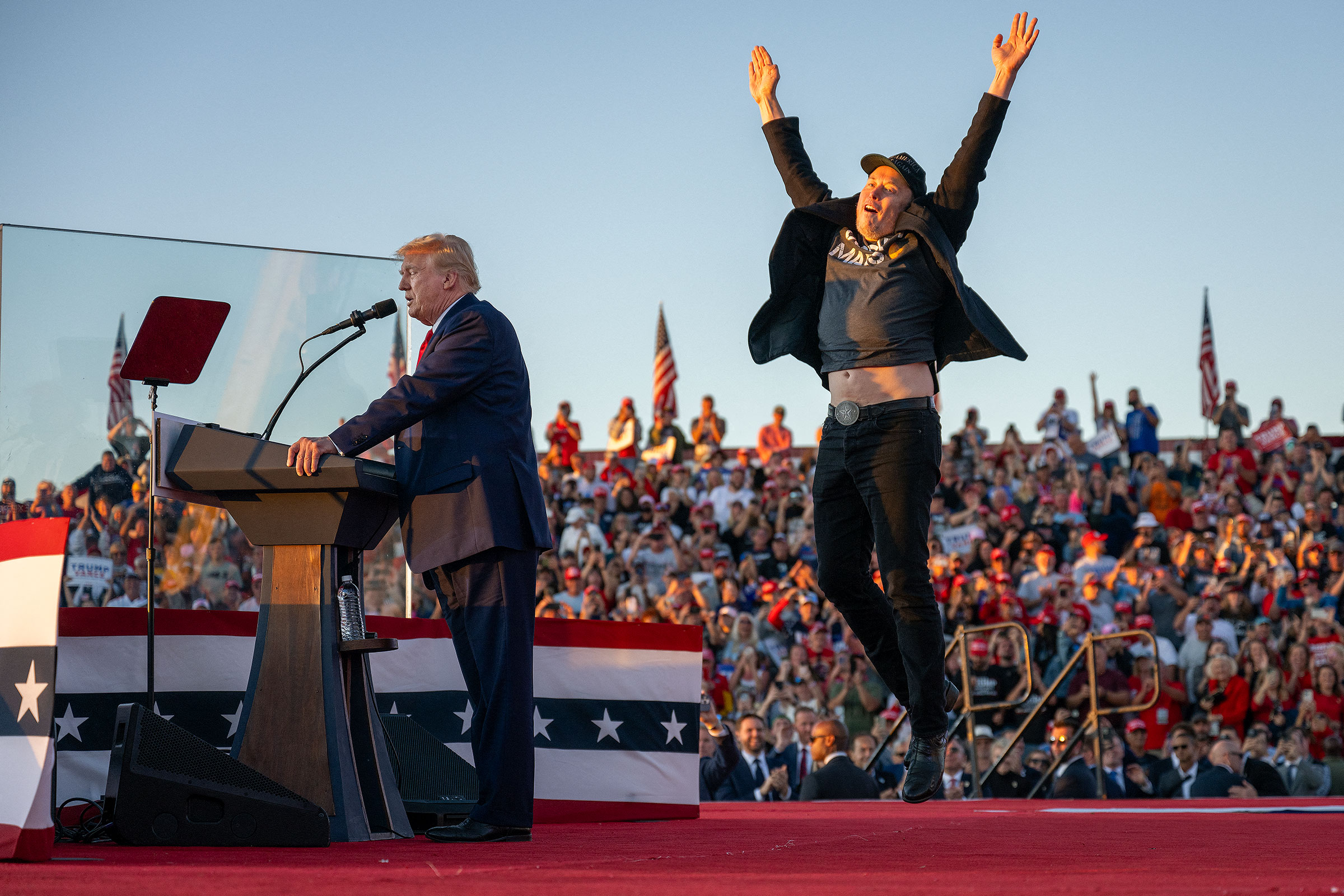 Elon Musk jumps on stage as he joins Trump during a campaign rally in Butler, Pa. on Oct. 5.