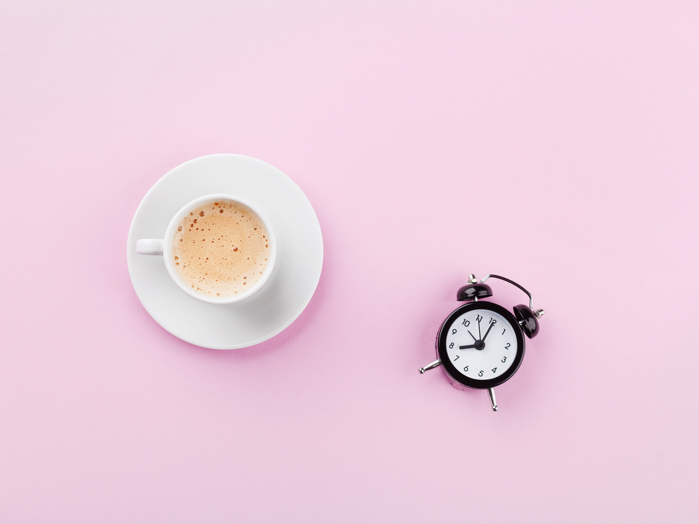 Alarm clock and morning coffee. Time to rest. Flat lay.