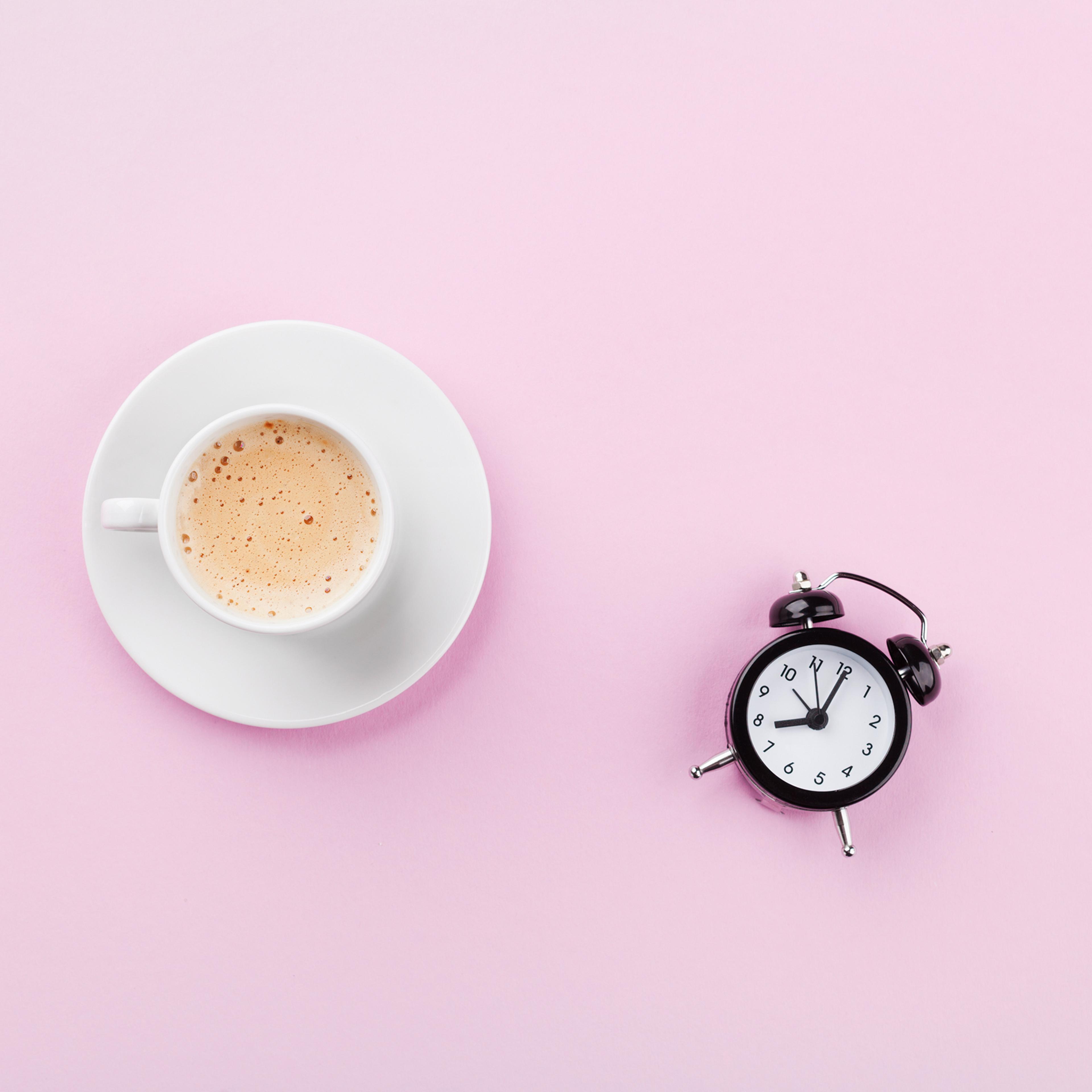 Alarm clock and morning coffee. Time to rest. Flat lay.