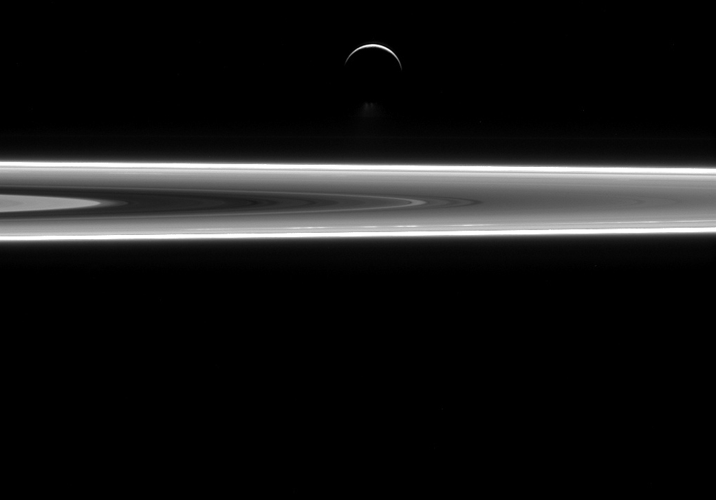 Enceladus over Saturn's rings.