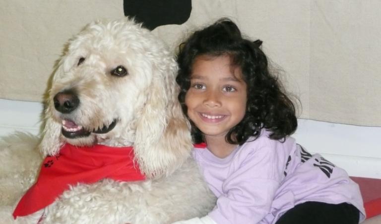 Ehlena Fry, of Michigan, is pictured in this undated photo with her goldendoodle service dog, Wonder.