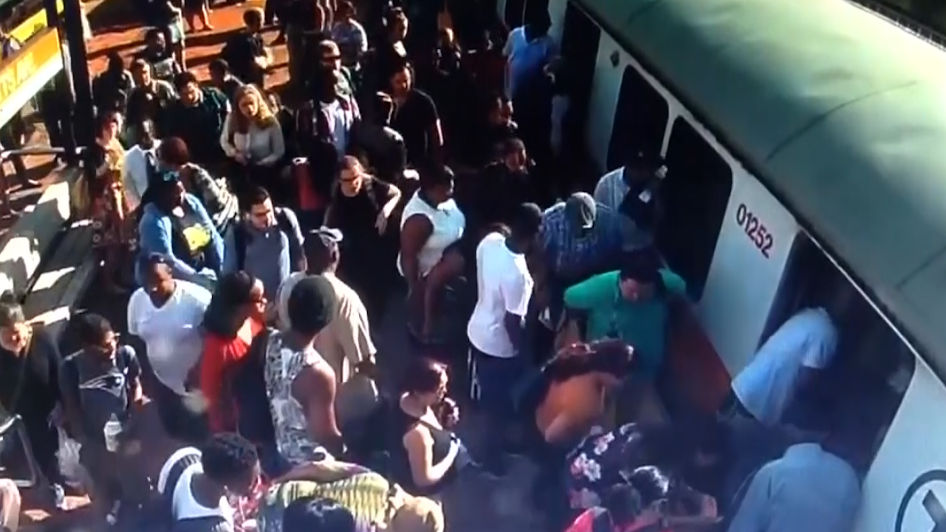Boston train Passengers rush to help a woman whose leg is caught between the platform and the train.