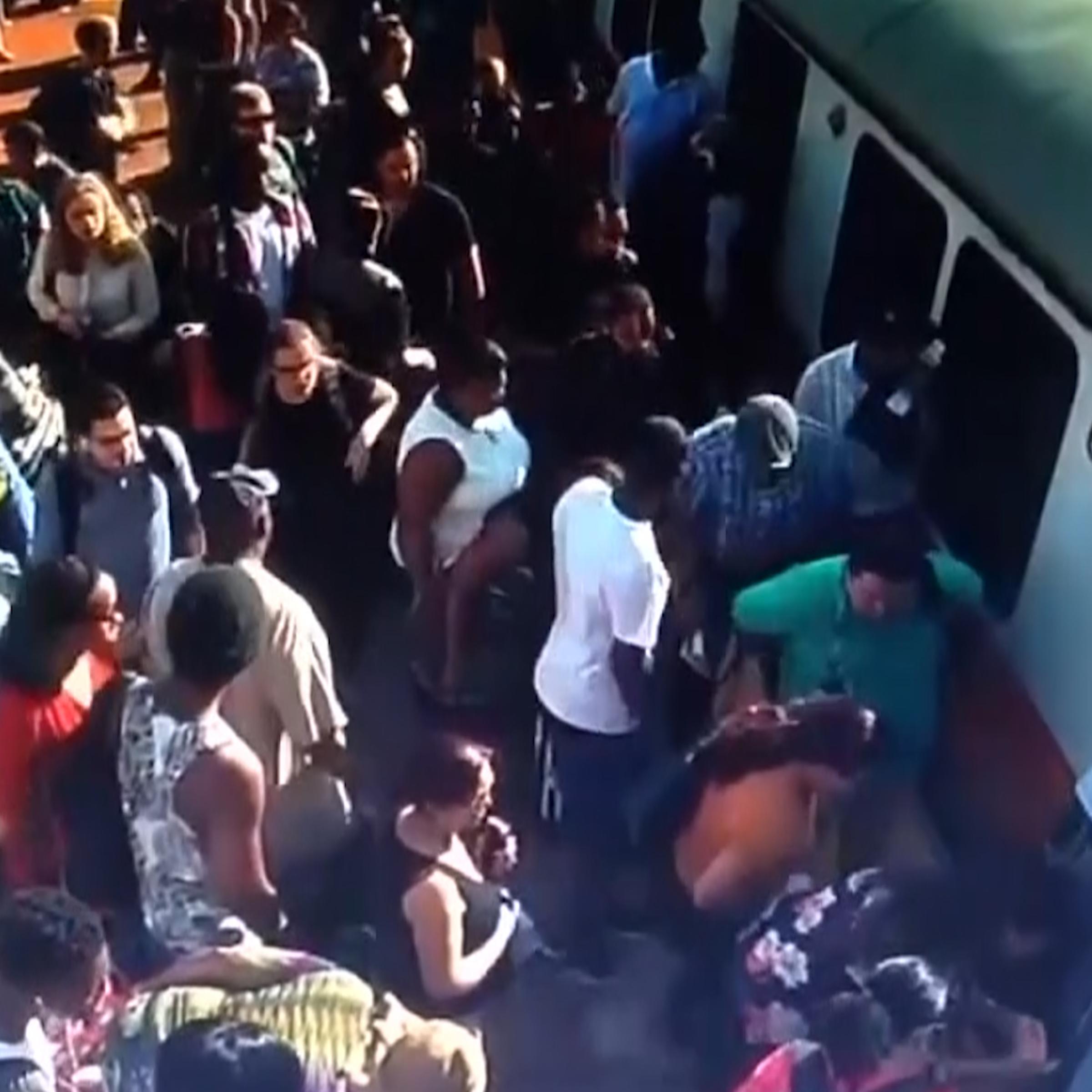 Boston train Passengers rush to help a woman whose leg is caught between the platform and the train.