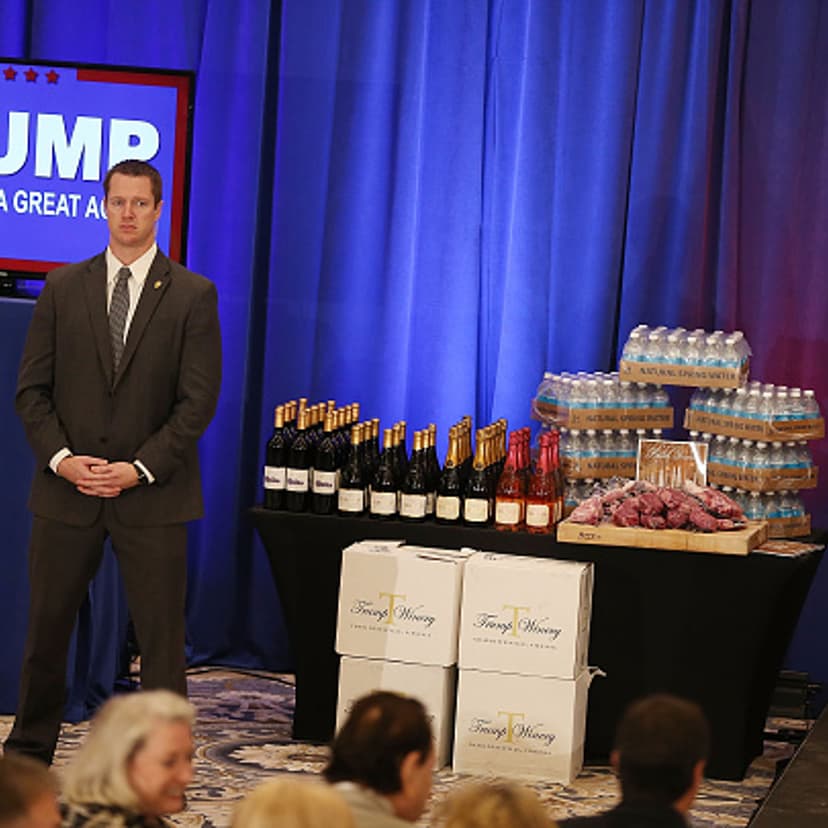 A security agent stands near a display of products that Republican presidential candidate Donald Trump has for guests, including meat, wine and water before a press conference at the Trump National Golf Club Jupiter on March 8, 2016 in Jupiter, Florida.