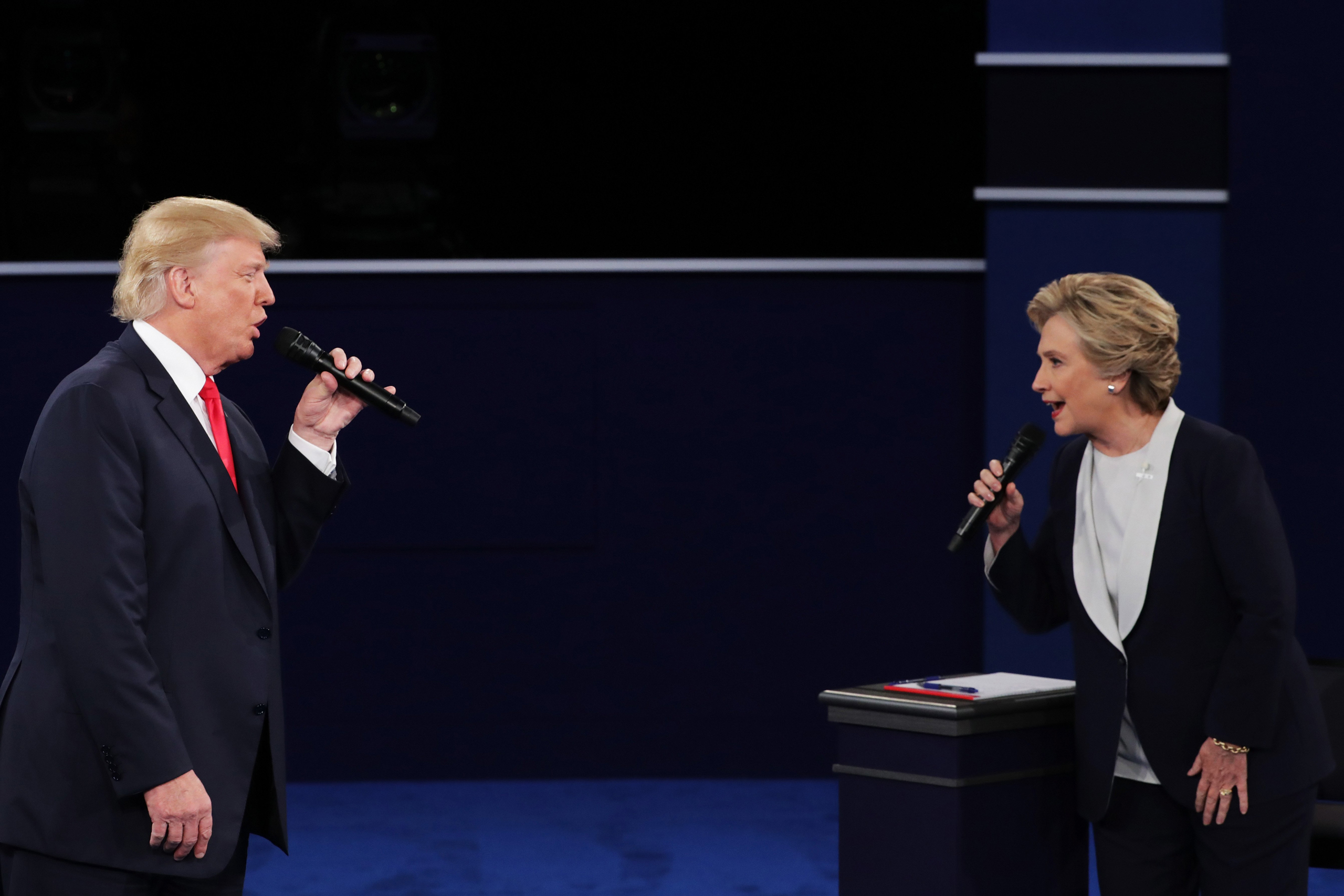 ST LOUIS, MO - OCTOBER 09: Democratic presidential nominee former Secretary of State Hillary Clinton (R) and Republican presidential nominee Donald Trump speak during the town hall debate at Washington University on October 9, 2016 in St Louis, Missouri.