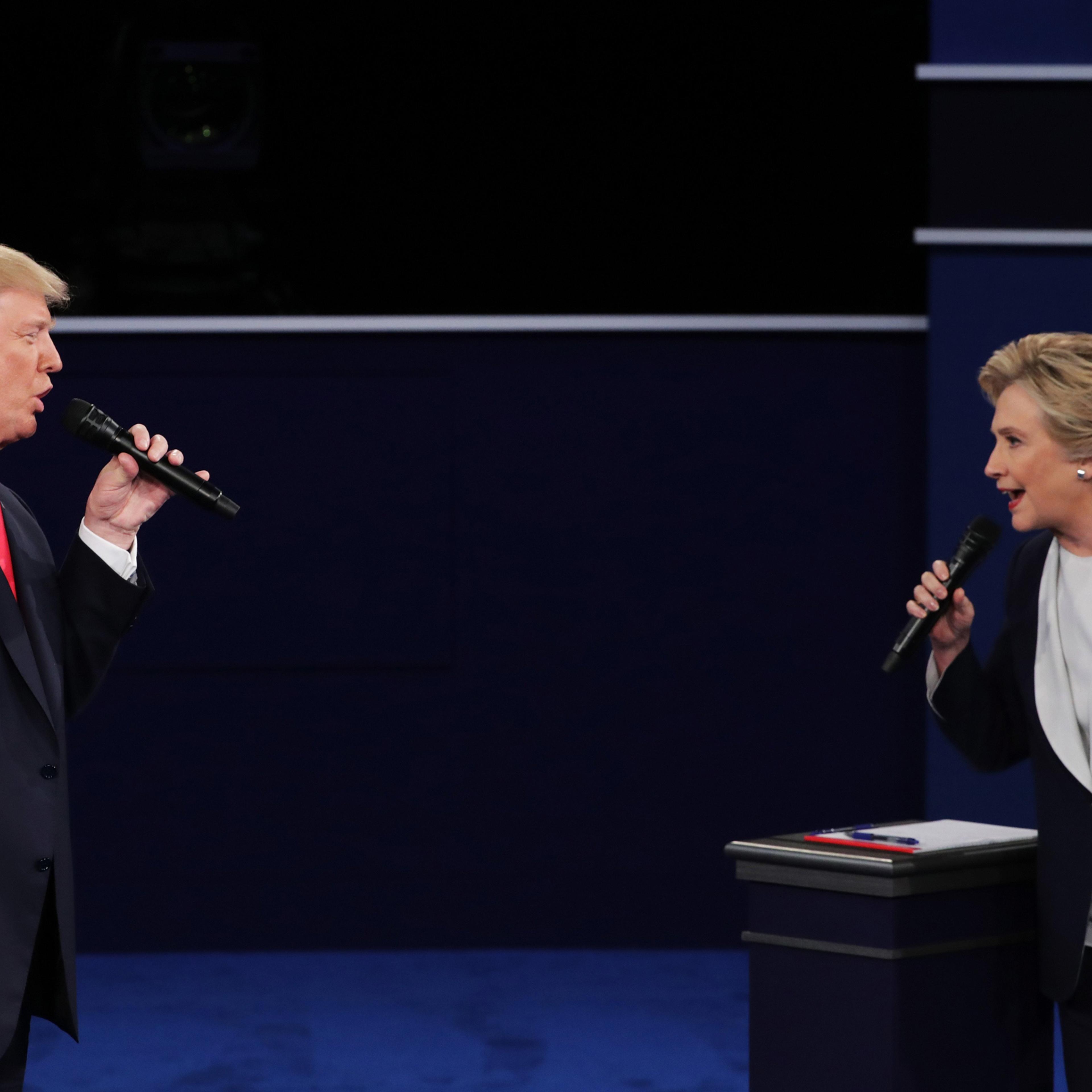 ST LOUIS, MO - OCTOBER 09: Democratic presidential nominee former Secretary of State Hillary Clinton (R) and Republican presidential nominee Donald Trump speak during the town hall debate at Washington University on October 9, 2016 in St Louis, Missouri.