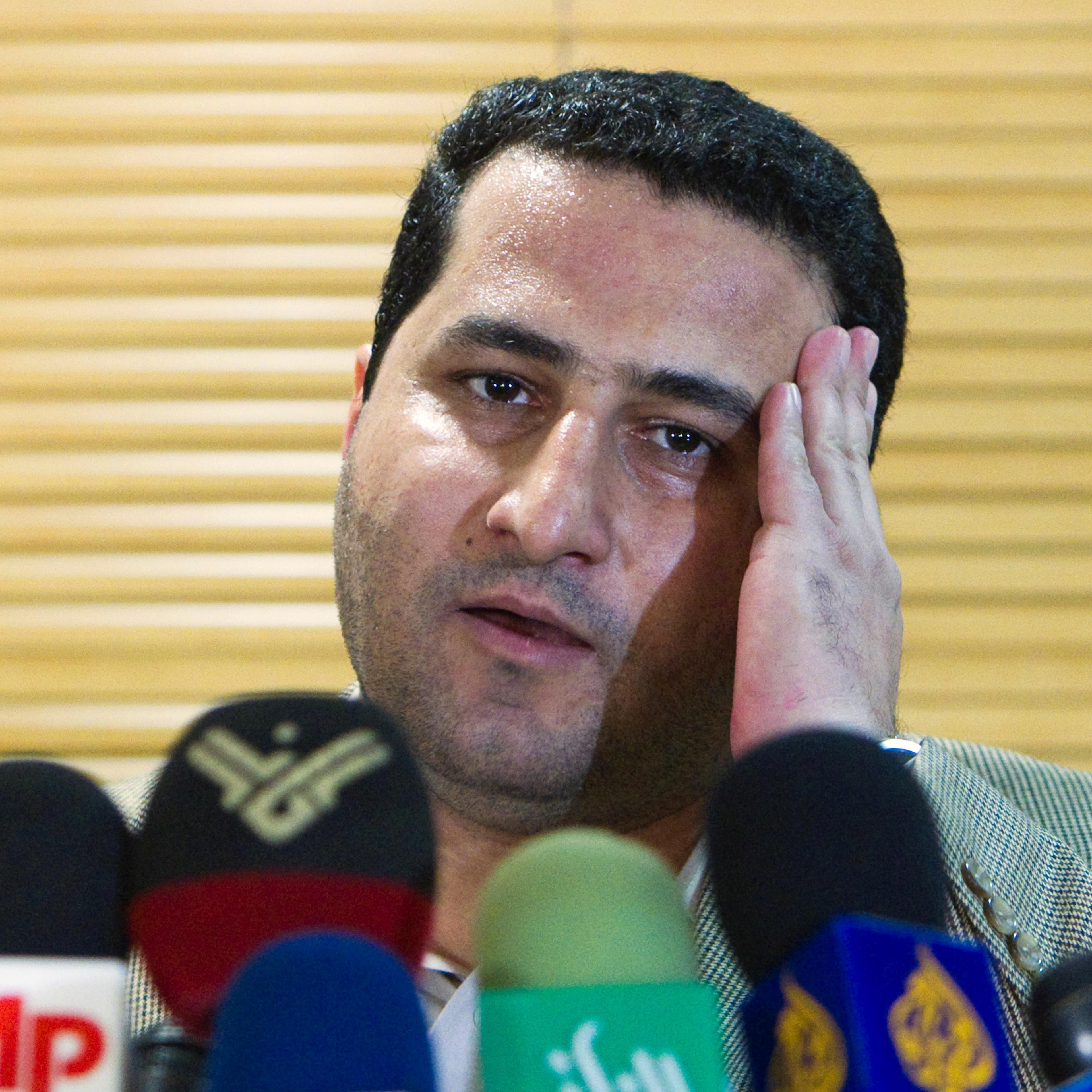 Iranian scientist Shahram Amiri speaks to journalists as he arrives at the Imam Khomini Airport in Tehran