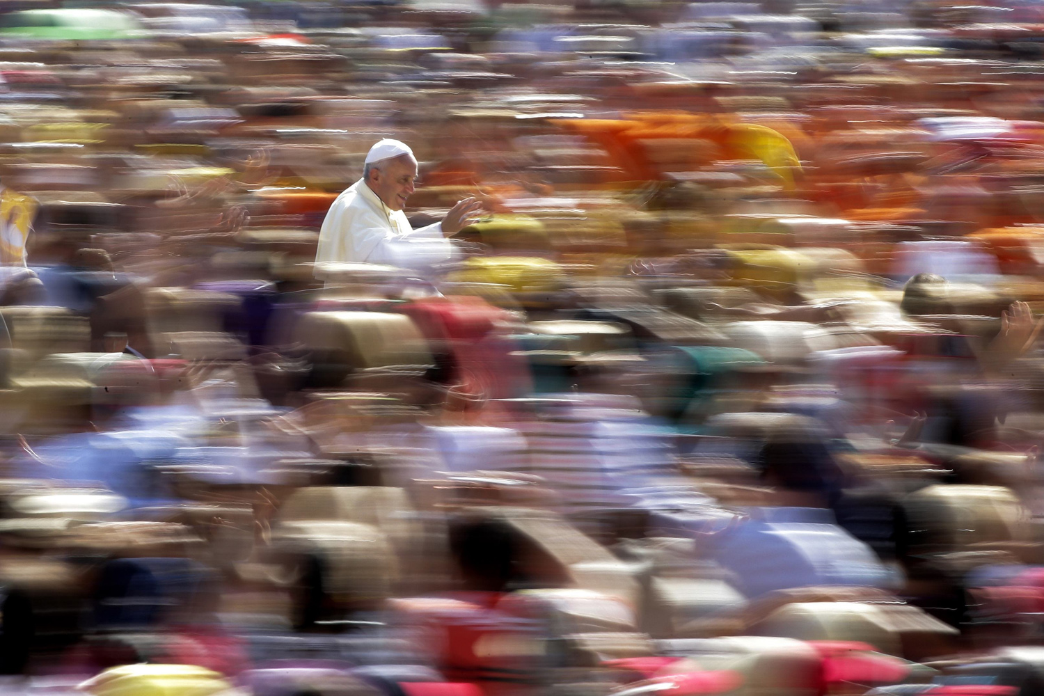 Pope Francis waves as he arrives to lead his weekly audience in Saint Peter's Square at the Vatican