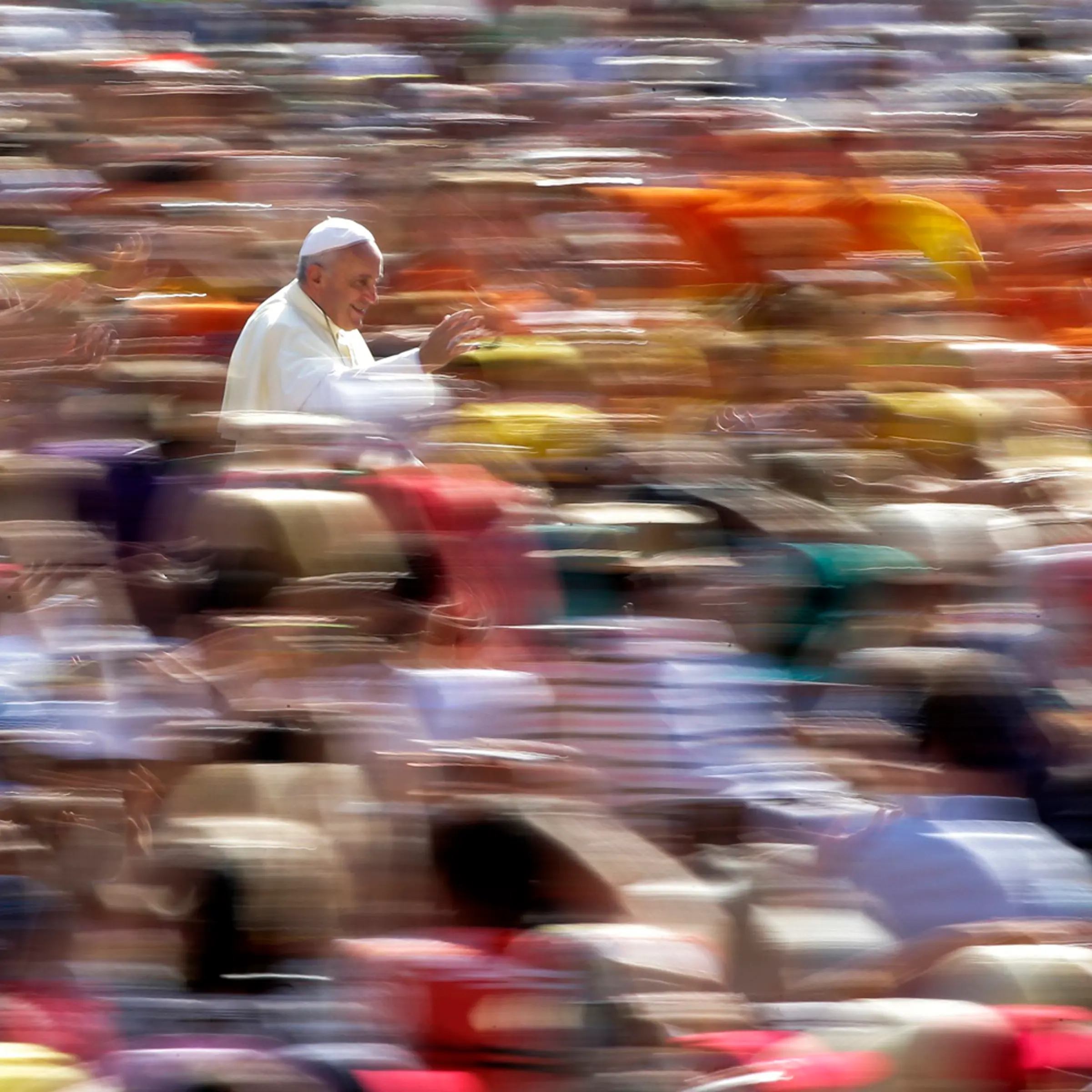 Pope Francis waves as he arrives to lead his weekly audience in Saint Peter's Square at the Vatican