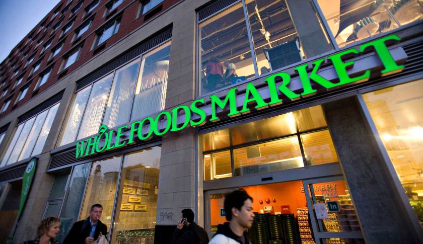 Pedestrians walk outside a newly opened Whole Foods Market o