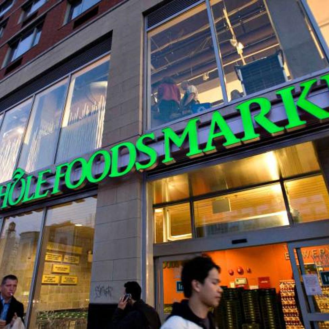Pedestrians walk outside a newly opened Whole Foods Market o