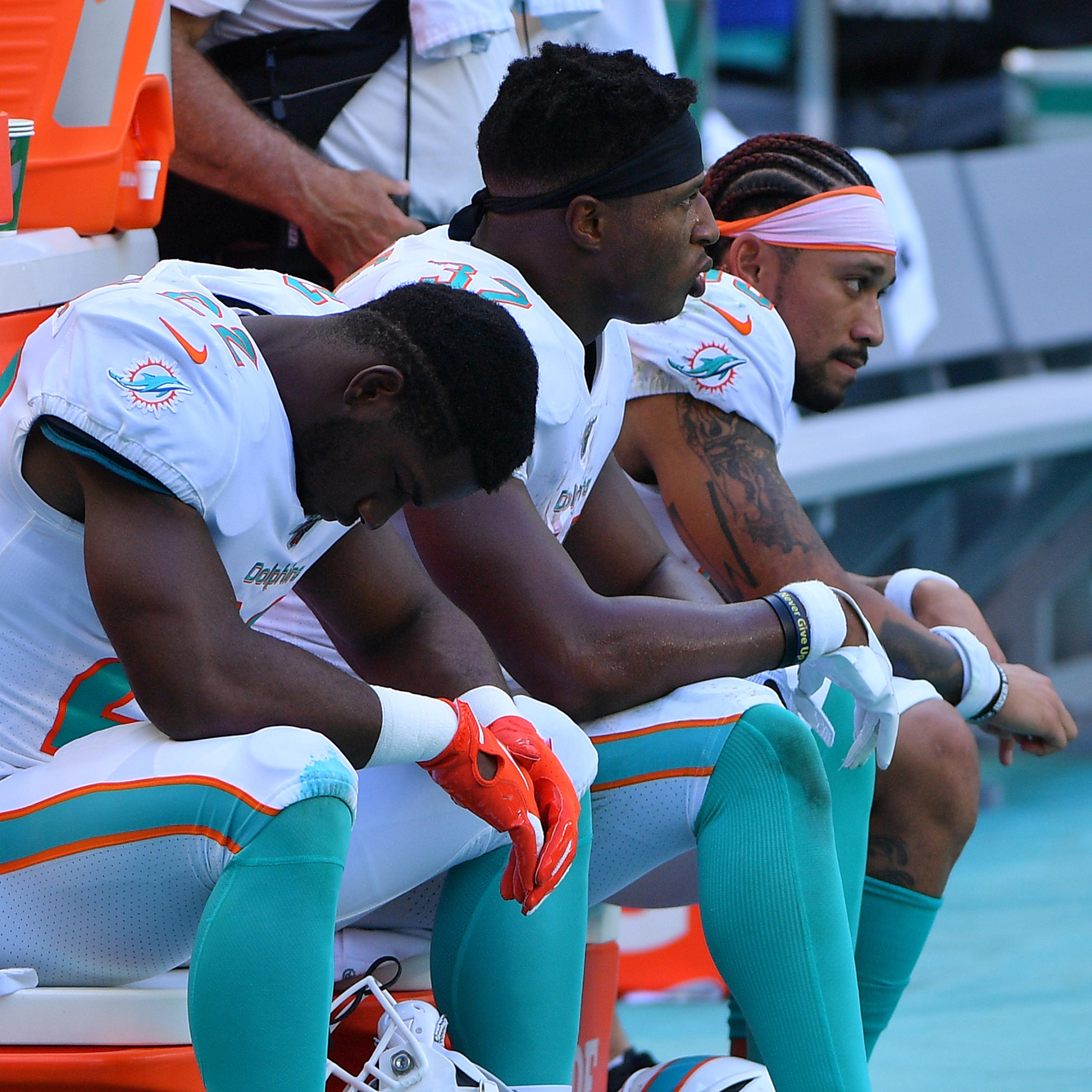 Miami players take in a 59-10 loss to Baltimore on Sept. 8