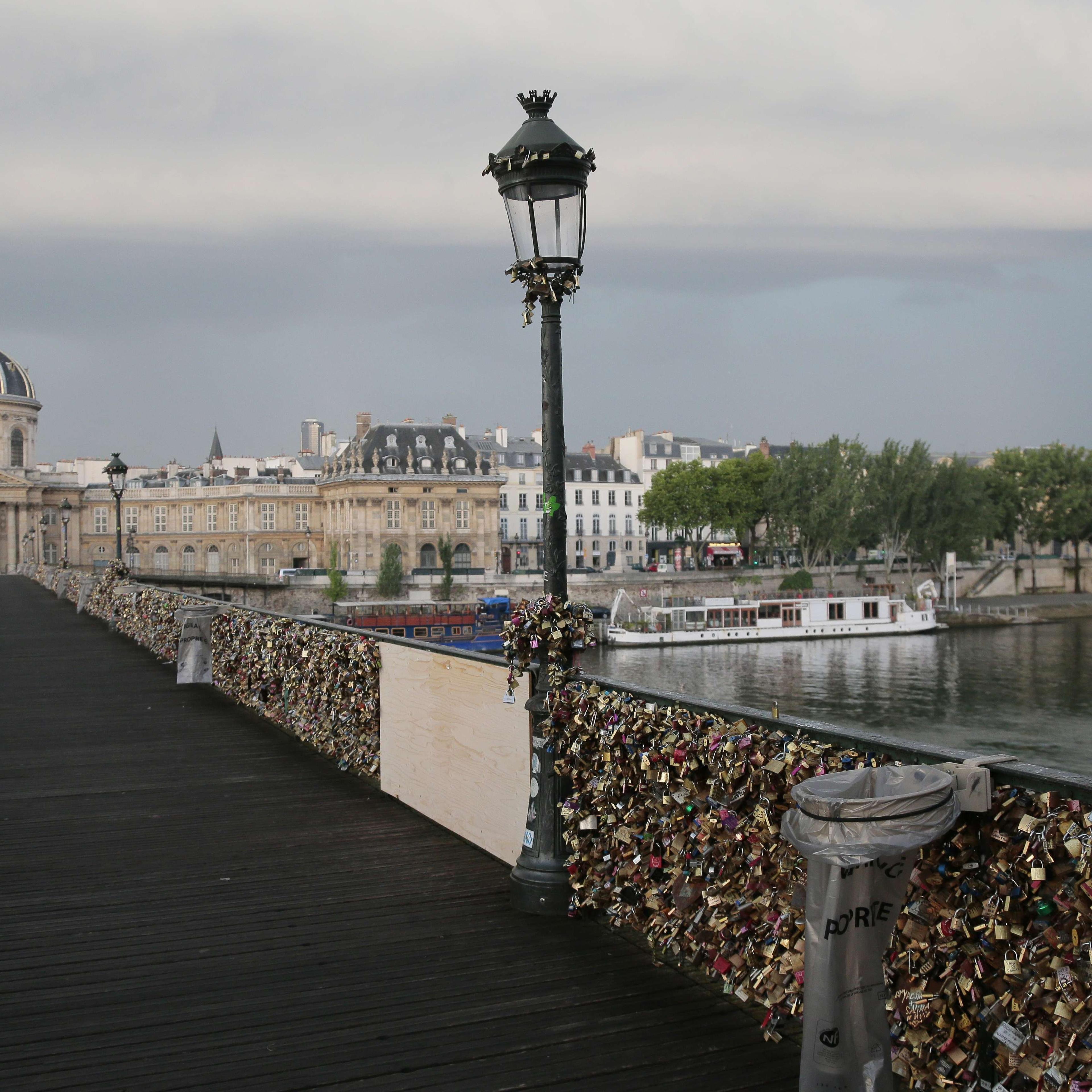 'Love padlocks' attached to a fence of the Pont des Arts bridge over the Seine river in Paris on June 9, 2014.