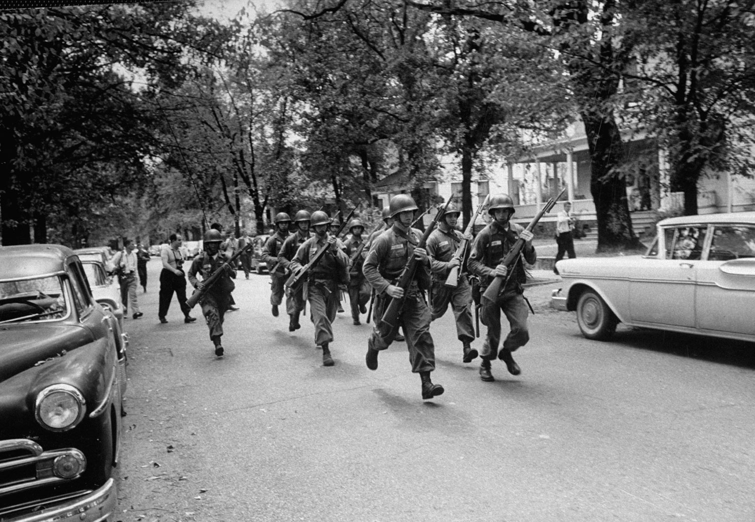 Troops race to break up a crowd protesting school integration, Little Rock, Arkansas, 1957.