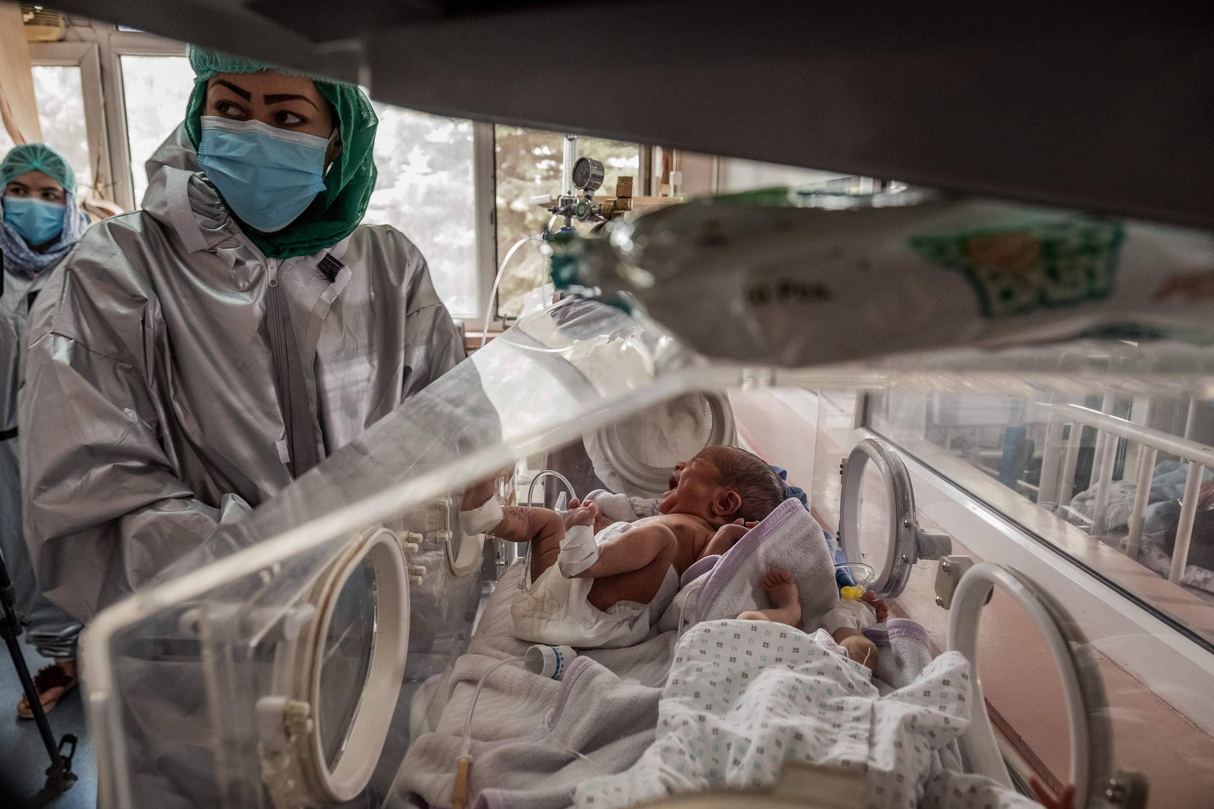 Nurses with newborns at Ataturk hospital in Kabul on May 13, 2020. These newborns were rescued during an attack on a maternity clinic a day earlier.