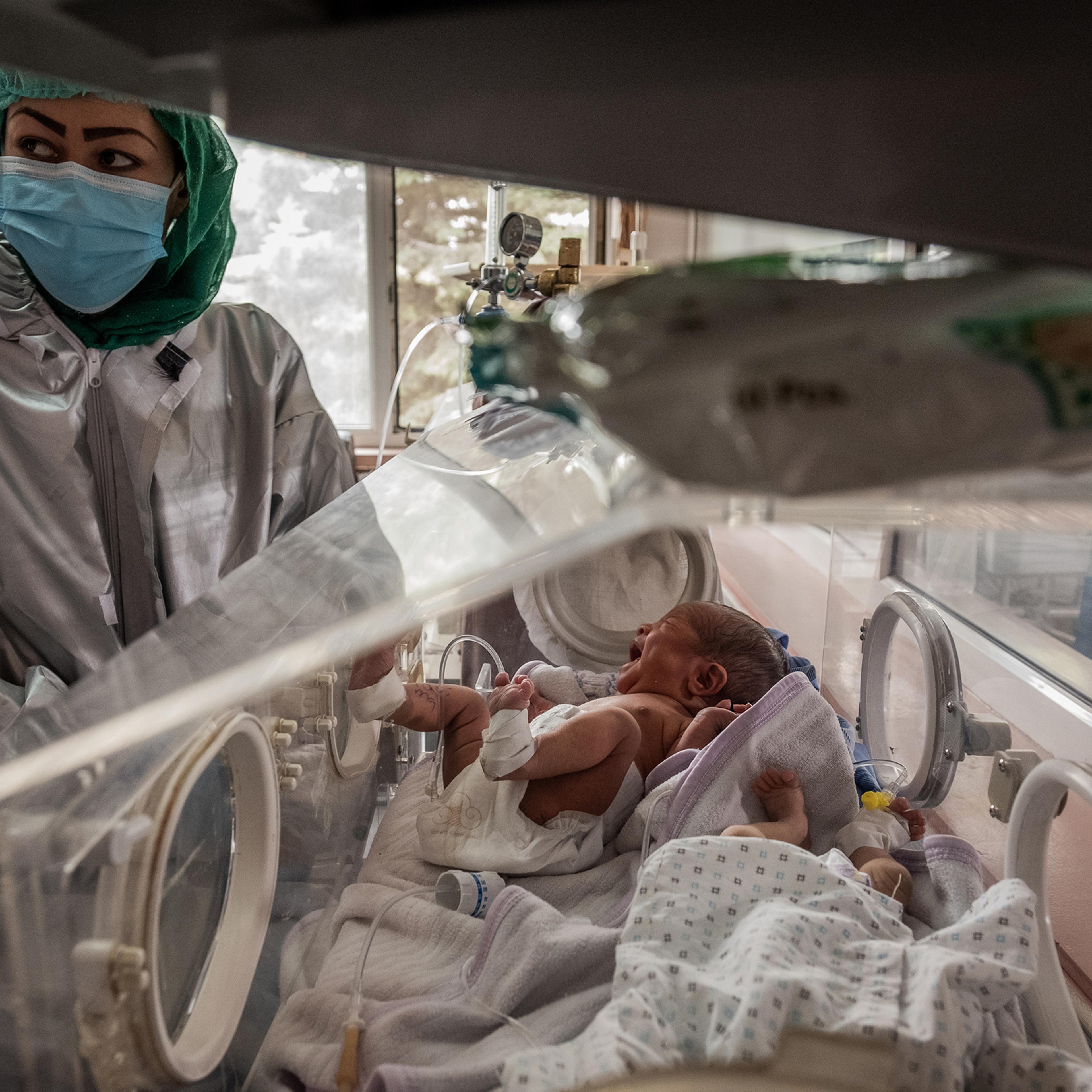 Nurses with newborns at Ataturk hospital in Kabul on May 13, 2020. These newborns were rescued during an attack on a maternity clinic a day earlier.