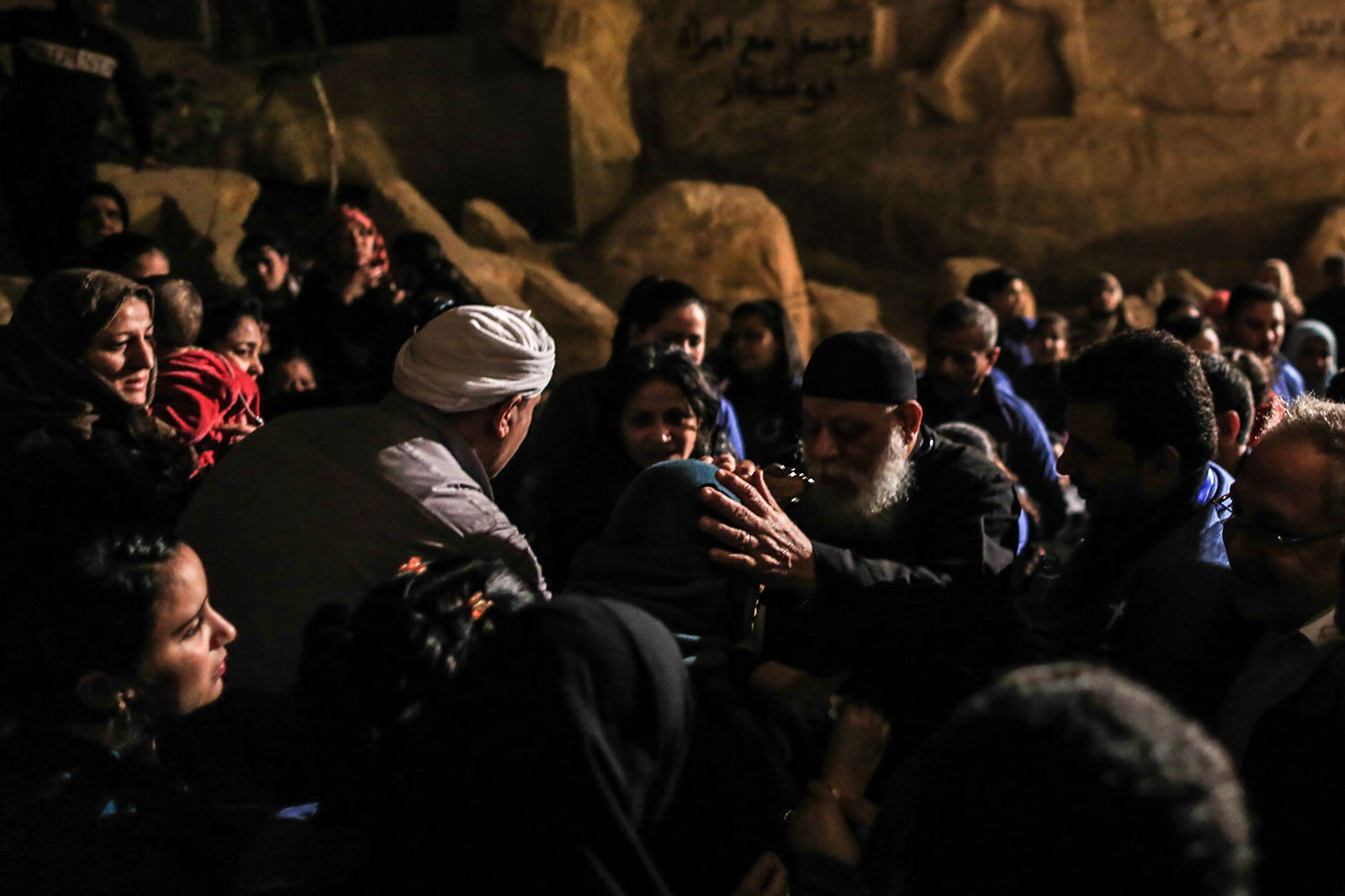 Father Sama’an Ibrahim performs an exorcism on a group of devotees - Muslims and Christians - inside Cairo’s St. Sama’an Cathedral, Feb. 28, 2014.