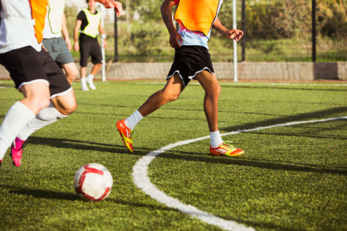soccer-players-playing-field