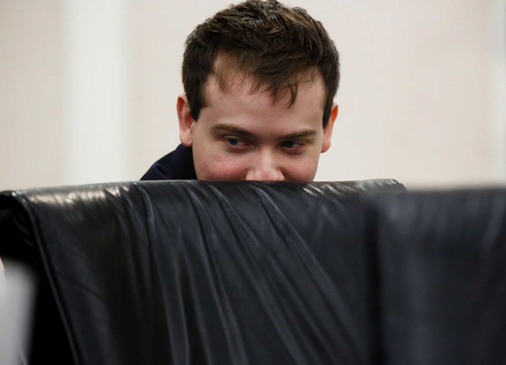 Defendant Pedro Bravo looks at something on the laptop of defense team member J.D. Thomas during his murder trial at the Alachua County Criminal Justice Center in Gainesville, Fla., on Aug. 12, 2014 