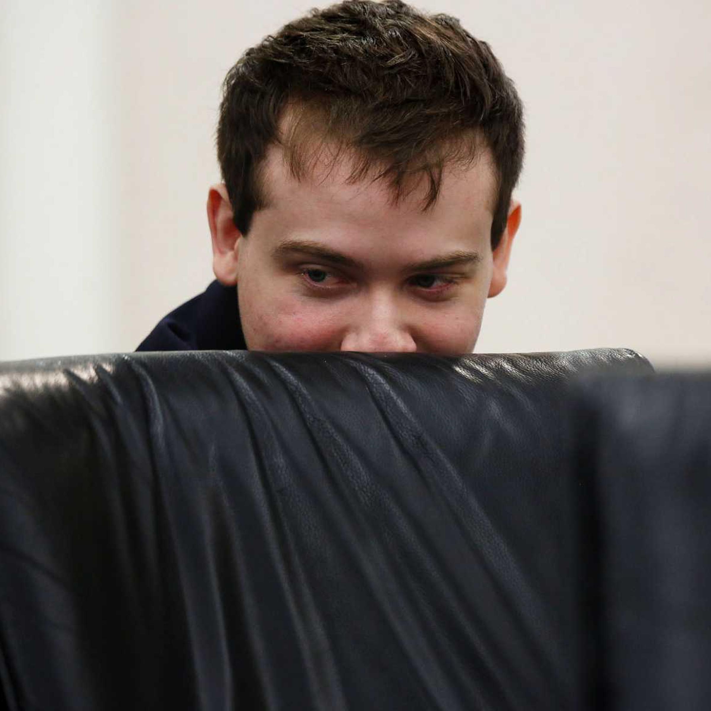 Defendant Pedro Bravo looks at something on the laptop of defense team member J.D. Thomas during his murder trial at the Alachua County Criminal Justice Center in Gainesville, Fla., on Aug. 12, 2014