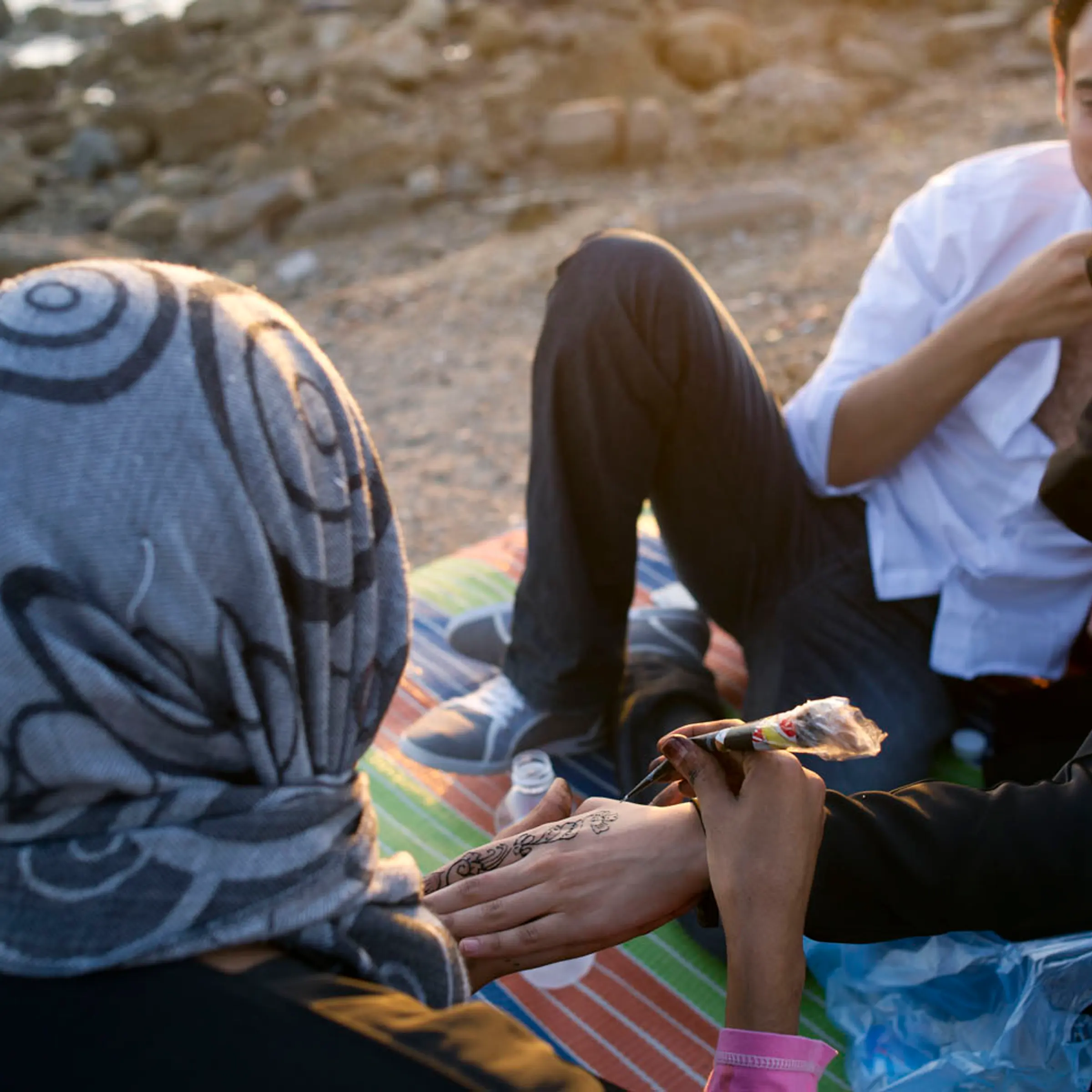 A woman has her hand painted with henna along the corniche in Jeddah, Saudi Arabia, June 14, 2011. Because of cultural and religious restrictions imposed on women in Saudi Arabia, women generally need a male guardian to accompany them out in public, and are often fully veiled as per tradition in Saudi Arabia.