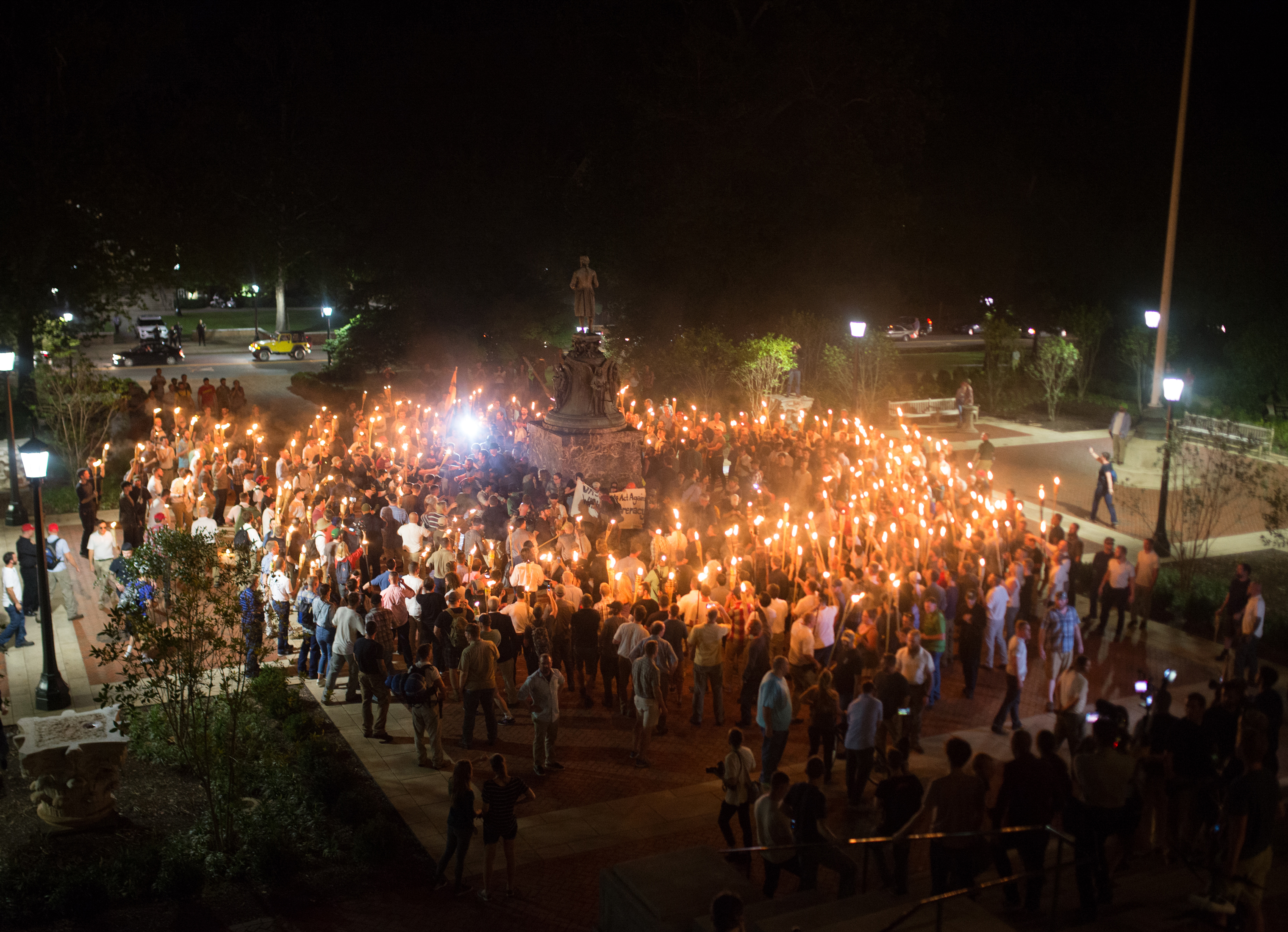 White nationalists encircle counter-protestors at the base of a statue of Thomas Jefferson after marching through the University of Virginia campus with torches in Charlottesville, Va., on Aug. 11, 2017.