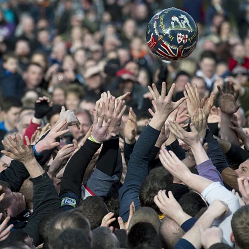Opposing teams of the Up'ards and the Down'ards reach for the ball as they compete in the annual Royal Shrovetide Football Match in Ashbourne, Derbyshire, England on February 17, 2015.