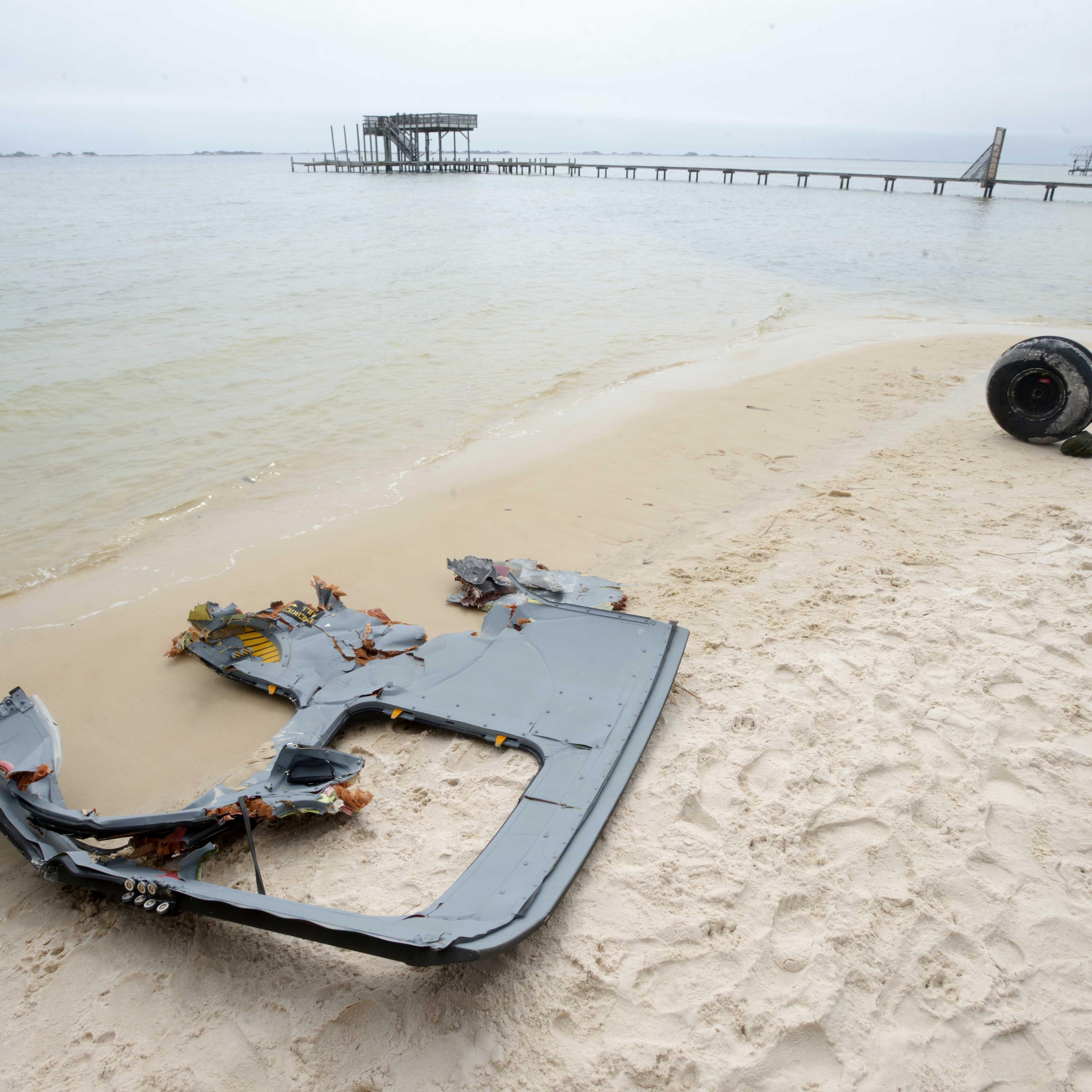 A wheel and pieces of fuselage from an Army Black Hawk helicopter sit along the shoreline of Santa Rosa Sound near Navarre, Fla. on Wednesday, March 11, 2015