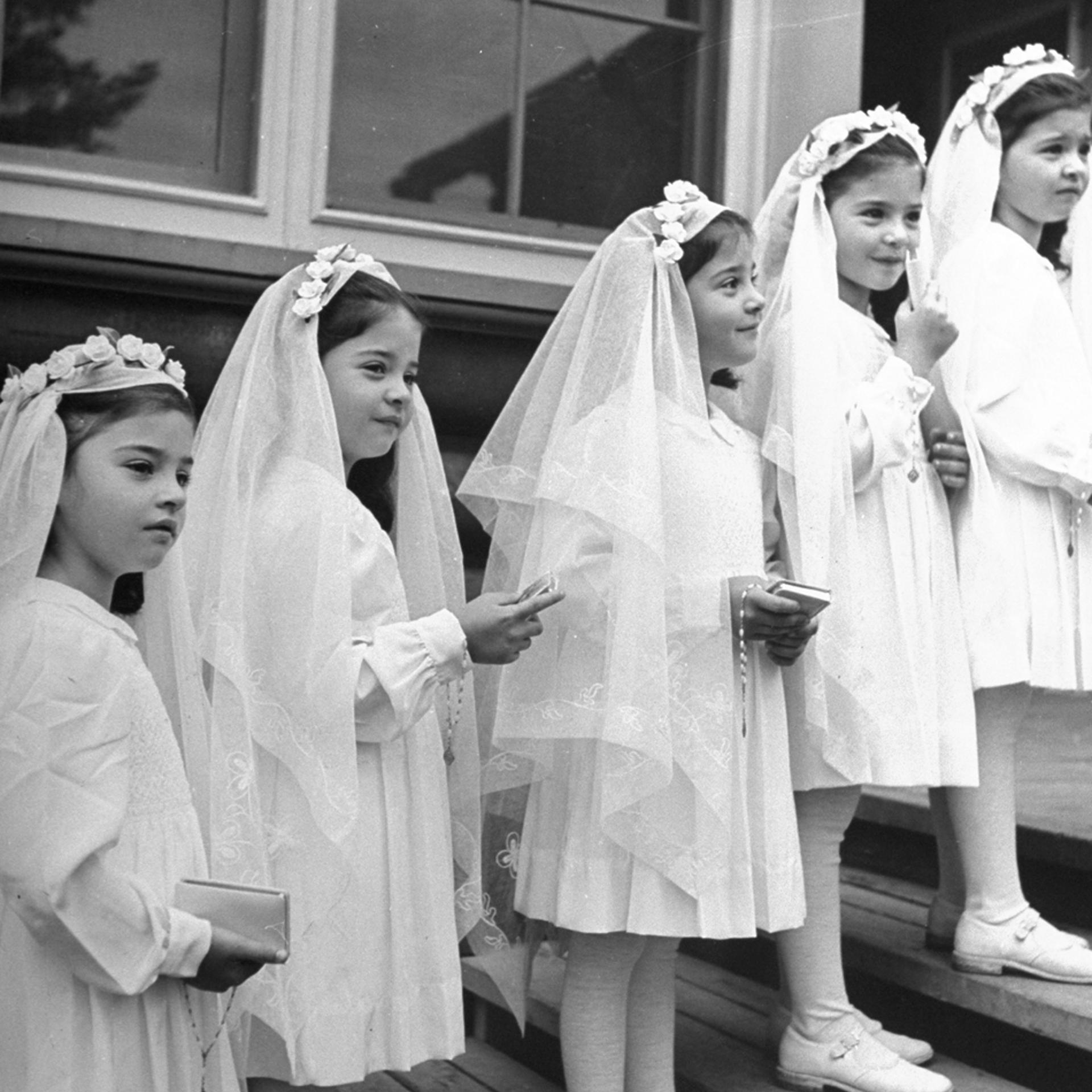 A view of the "Dionne Quintuplets" posing in their confirmation dresses on day of their first Holy Communion, 1940.