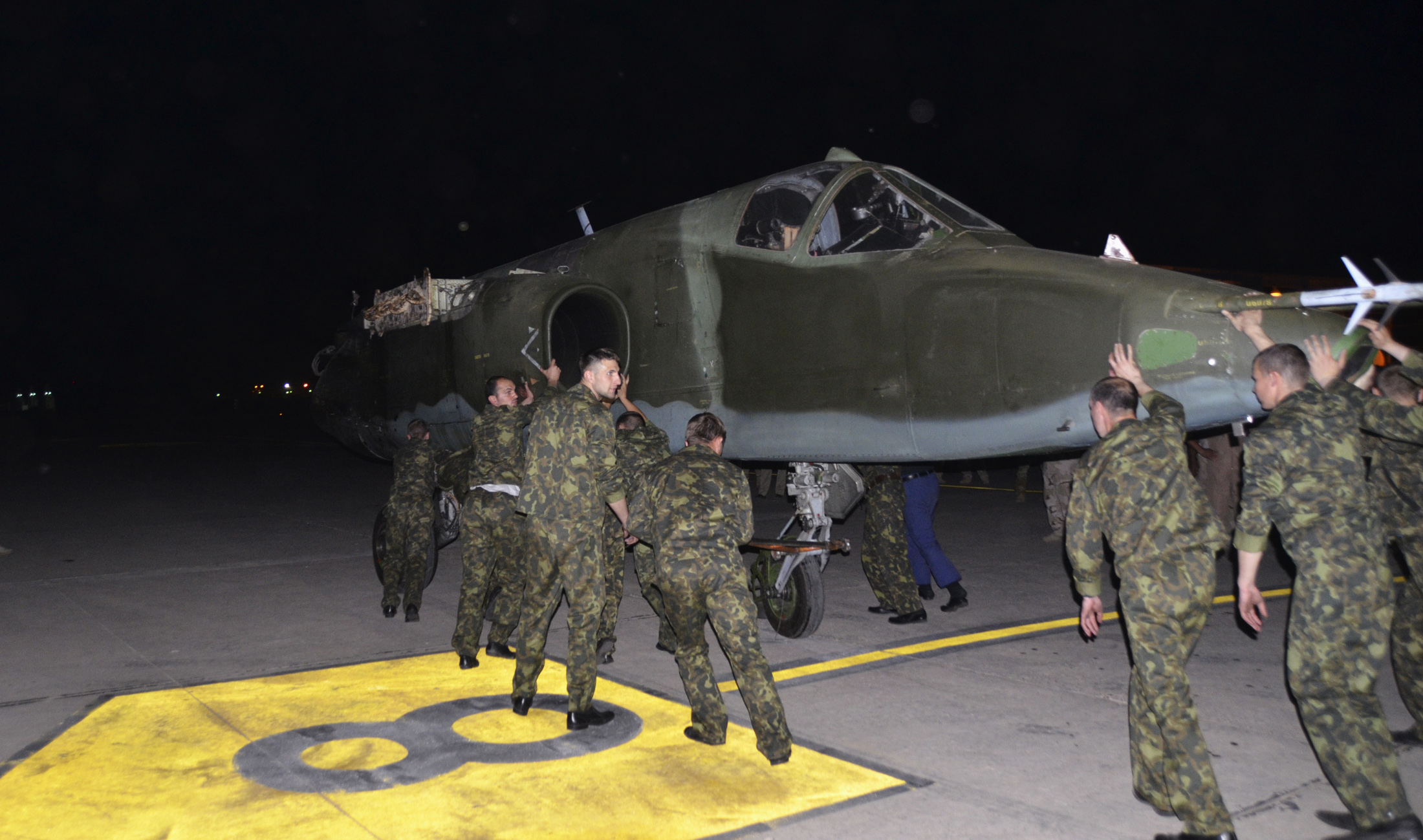 Russian soldiers unload Russian Sukhoi SU-25 plane in al-Muthanna Iraqi military base at Baghdad airport in Baghdad