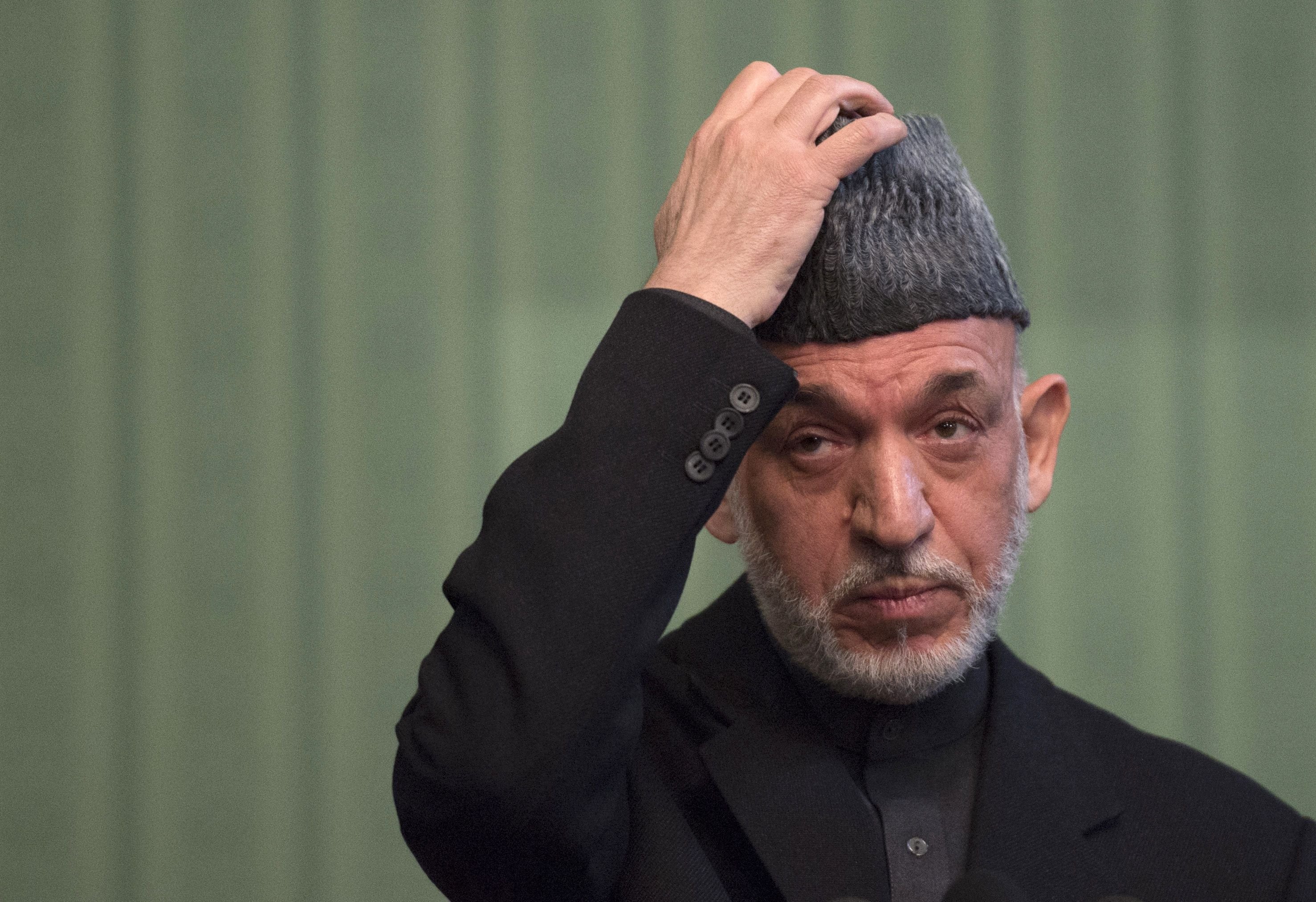 Afghan President Hamid Karzai gestures during a press conference at the Presidential Palace in Kabul on January 25, 2014.