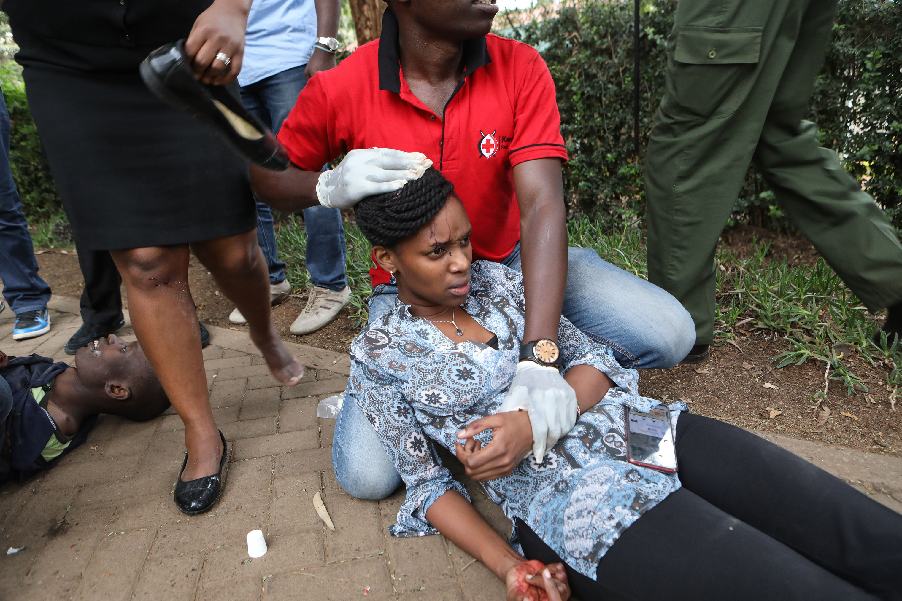 Kenyan Red Cross workers provide first aid to injured victims during an ongoing gunfire and explosions in Nairobi on Jan. 15, 2019.