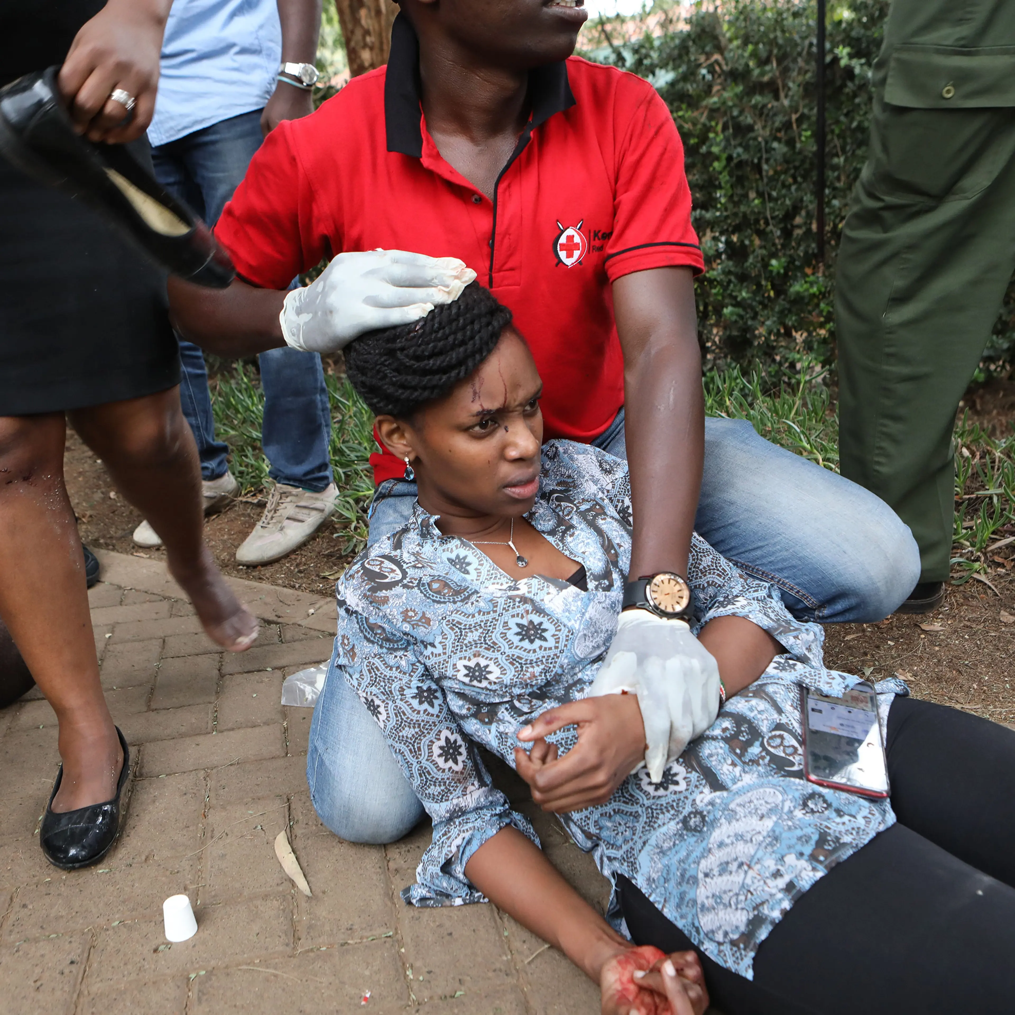 Kenyan Red Cross workers provide first aid to injured victims during an ongoing gunfire and explosions in Nairobi on Jan. 15, 2019.
