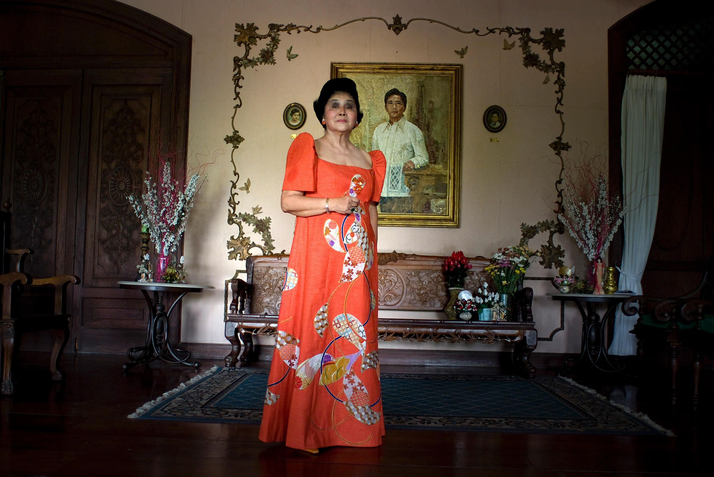 Imelda Marcos poses for a portrait in front of a painting of her late husband and former Philippines President Ferdinand Marcos, inside her home in Batac, Ilocos Norte, Philippines, in April 2010.