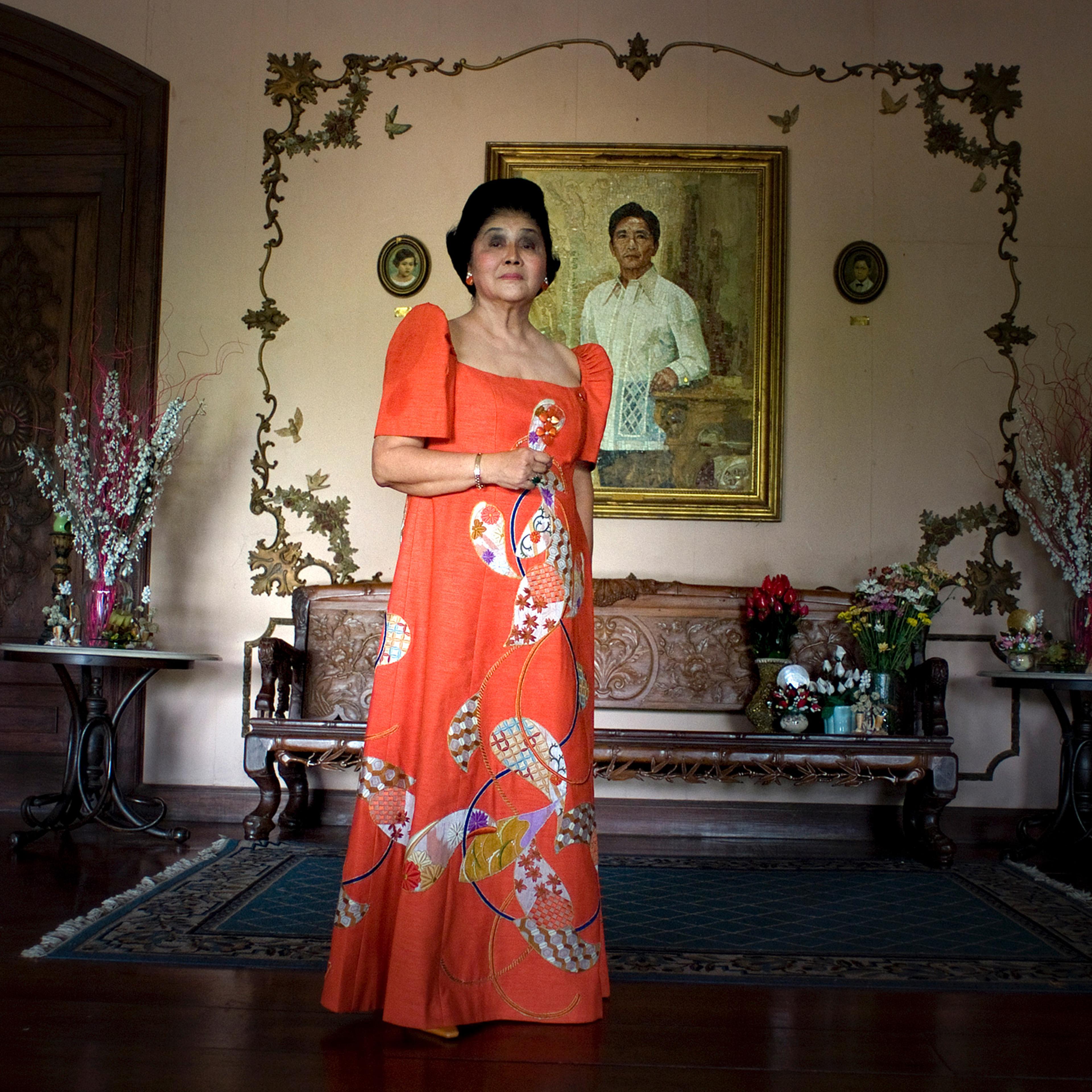 Imelda Marcos poses for a portrait in front of a painting of her late husband and former Philippines President Ferdinand Marcos, inside her home in Batac, Ilocos Norte, Philippines, in April 2010.