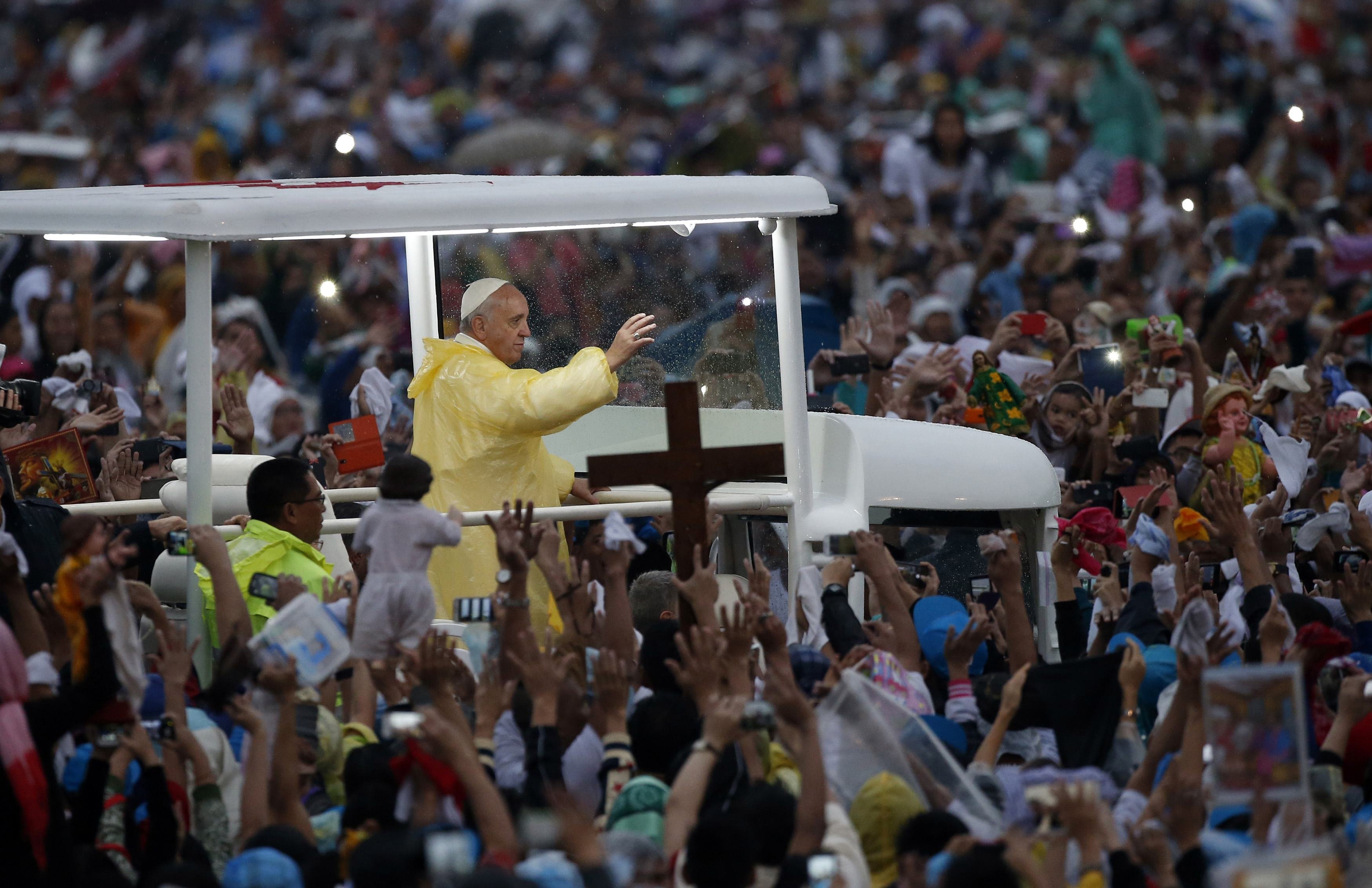 Pope Francis waves from the popemobile after leading a Mass at Rizal Park in Manila