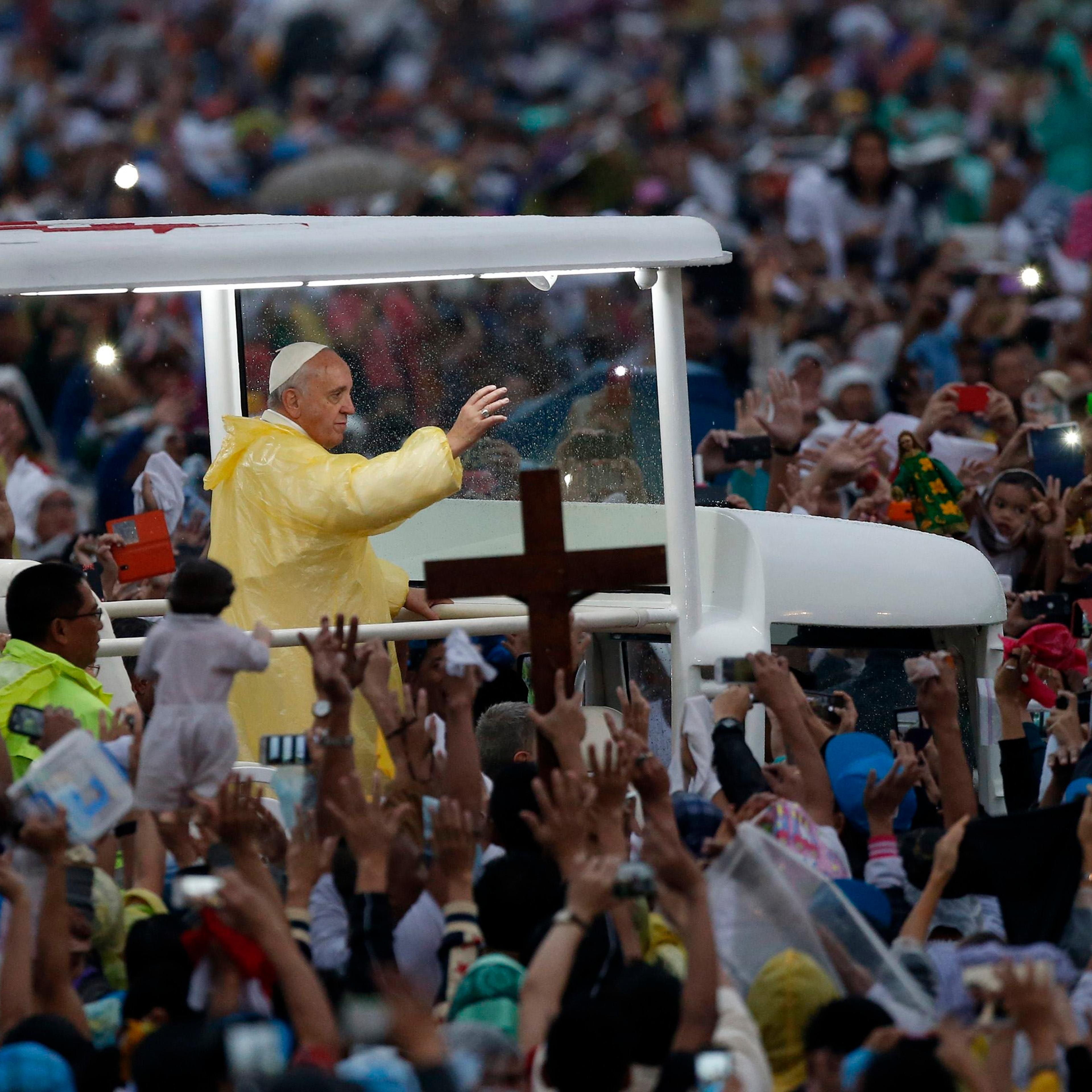 Pope Francis waves from the popemobile after leading a Mass at Rizal Park in Manila