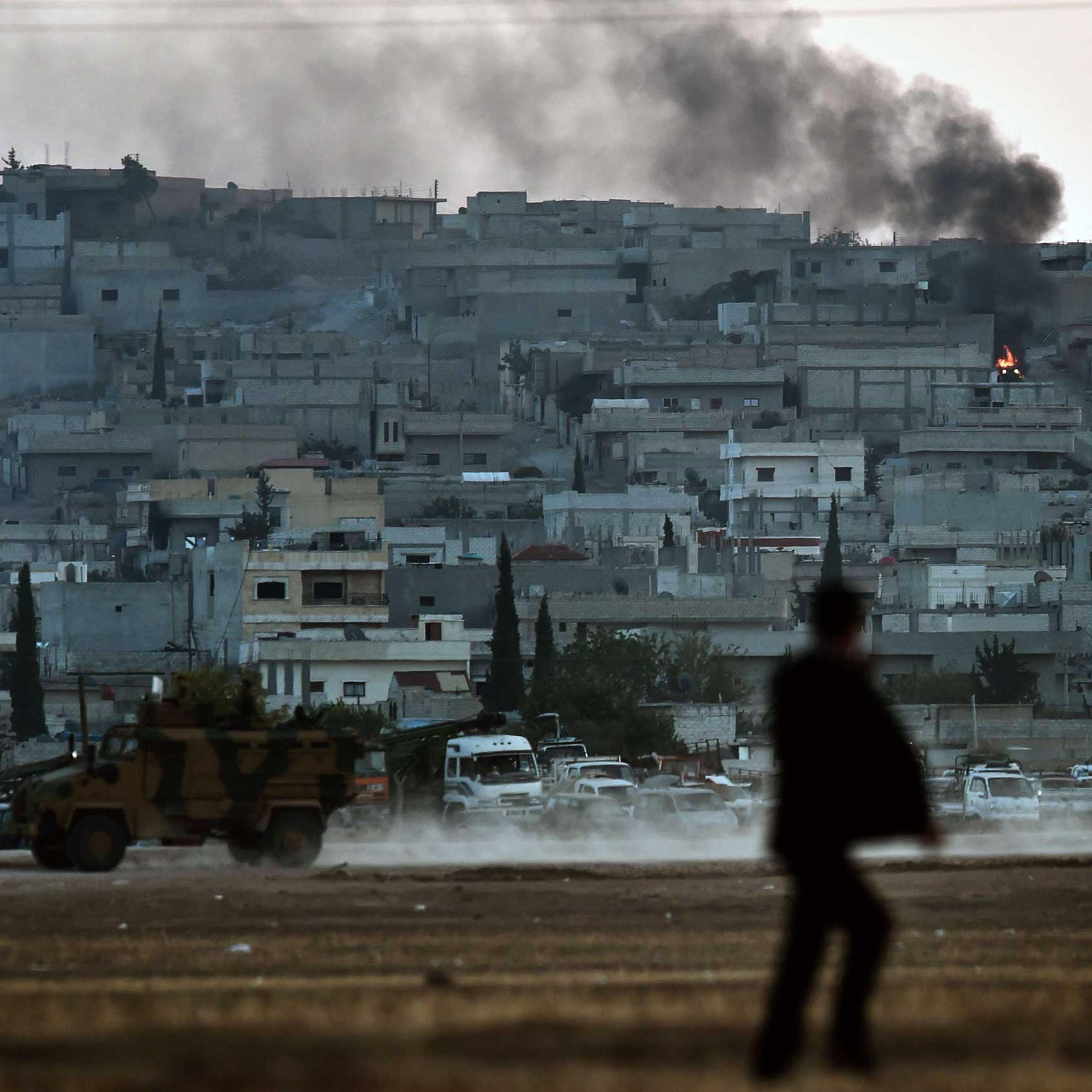 Smoke rises from the city centre of the Syrian town of Ain al-Arab, known as Kobani by the Kurds, as seen from the Turkish-Syrian border during heavy fighting, in the southeastern town of Suruc, Sanliurfa province, Turkey, on Oct. 7, 2014.